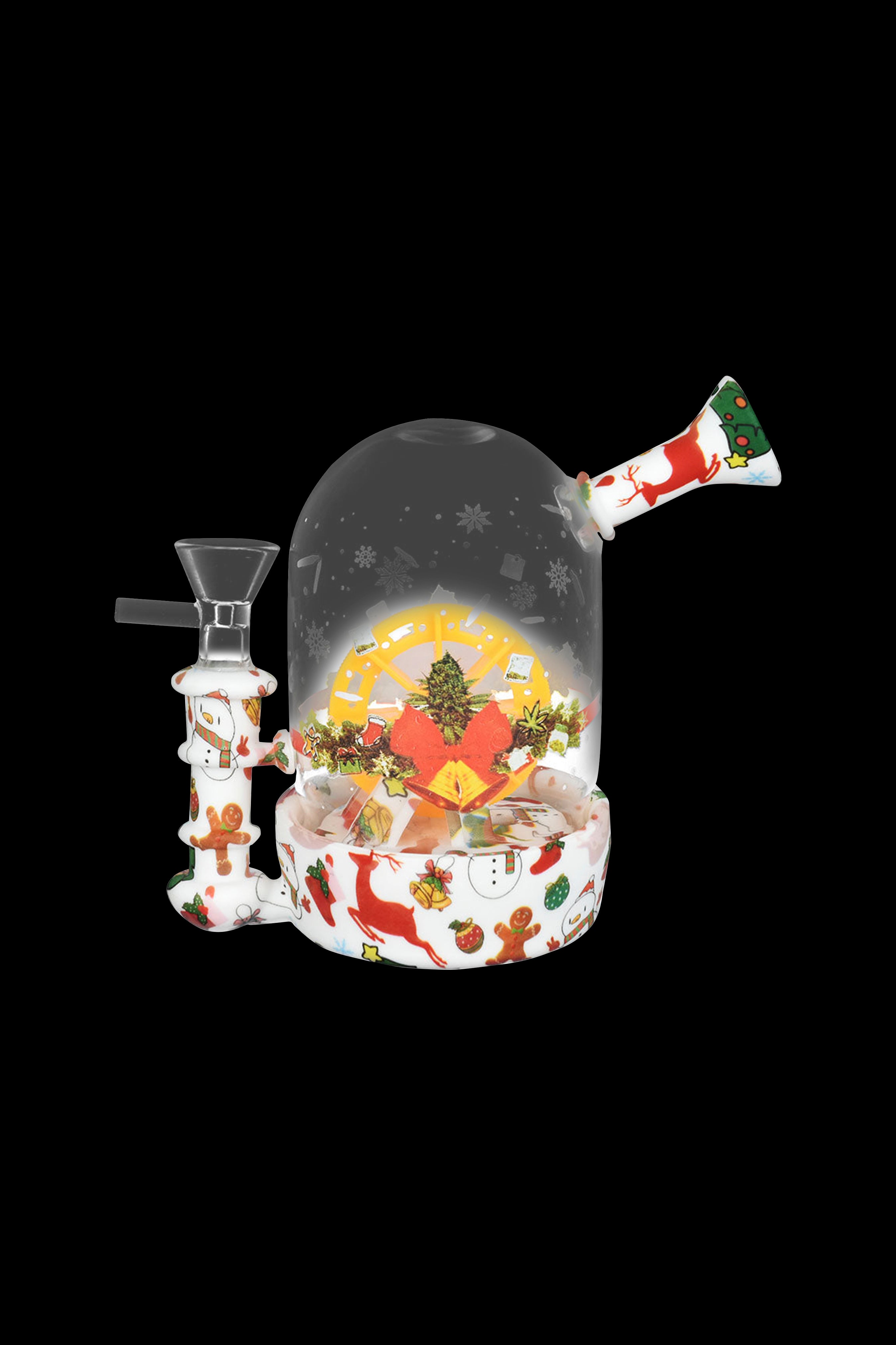 Festive cannabis water pipe resembling a snow globe with a miniature winter scene inside.