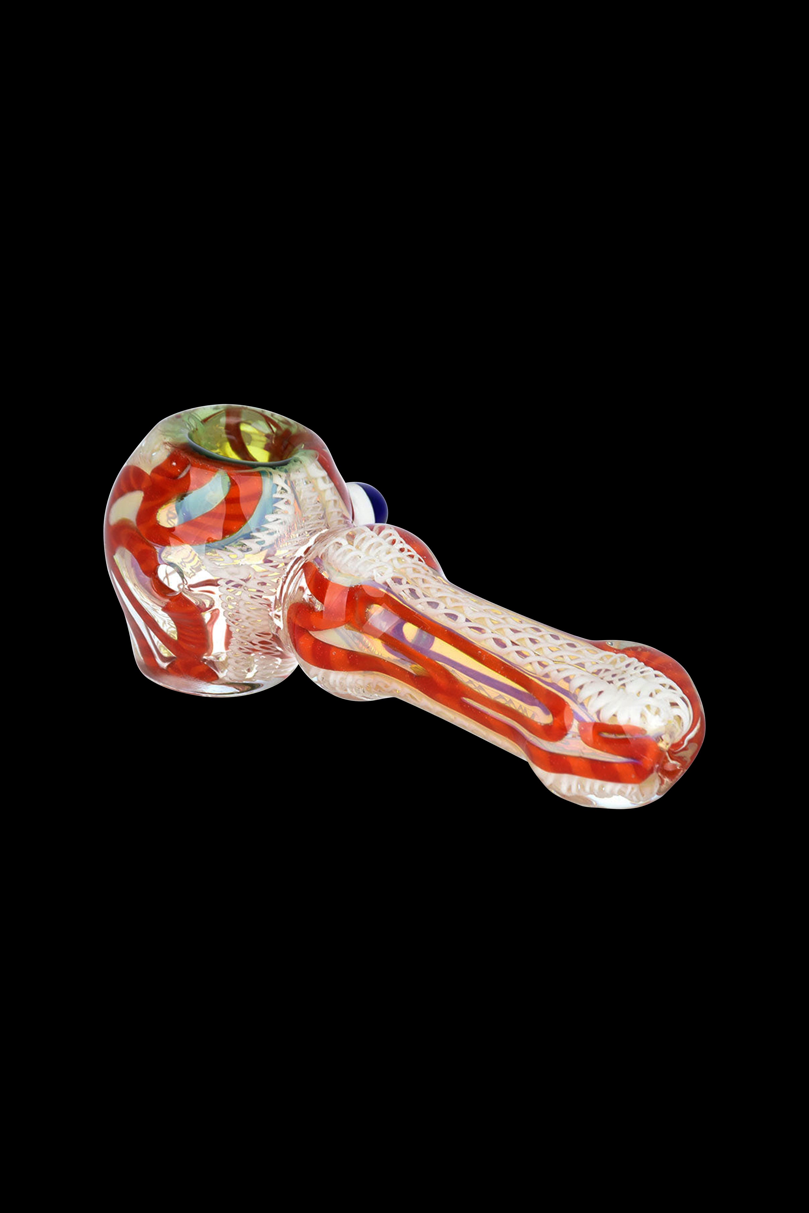 Red and orange glass pipe with intricate latticework detail, isolated on a black background.