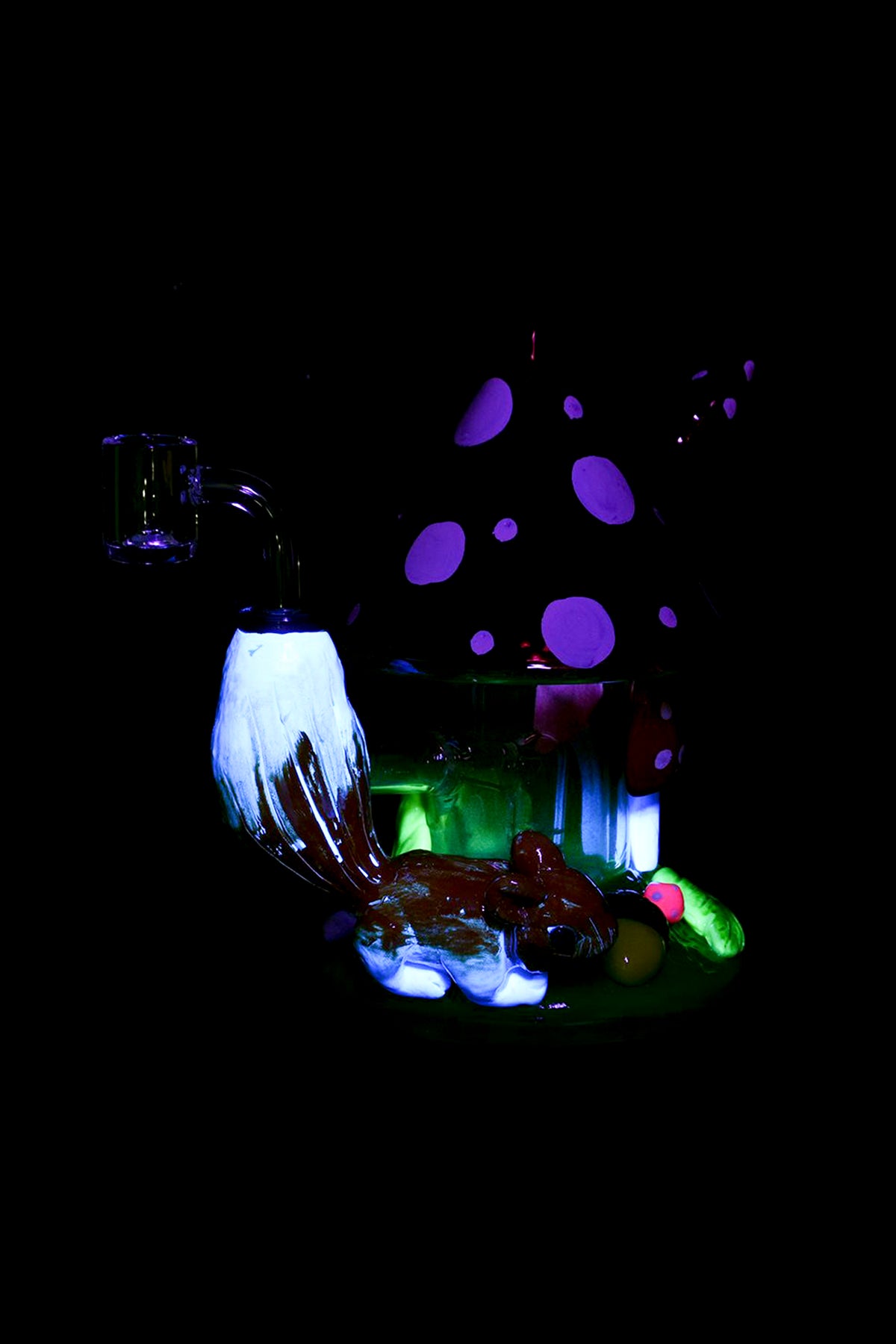 Psychedelic glass sculpture resembling mushrooms and alien flora, illuminated with vibrant purple and green lights, likely a display piece for a cannabis shop.