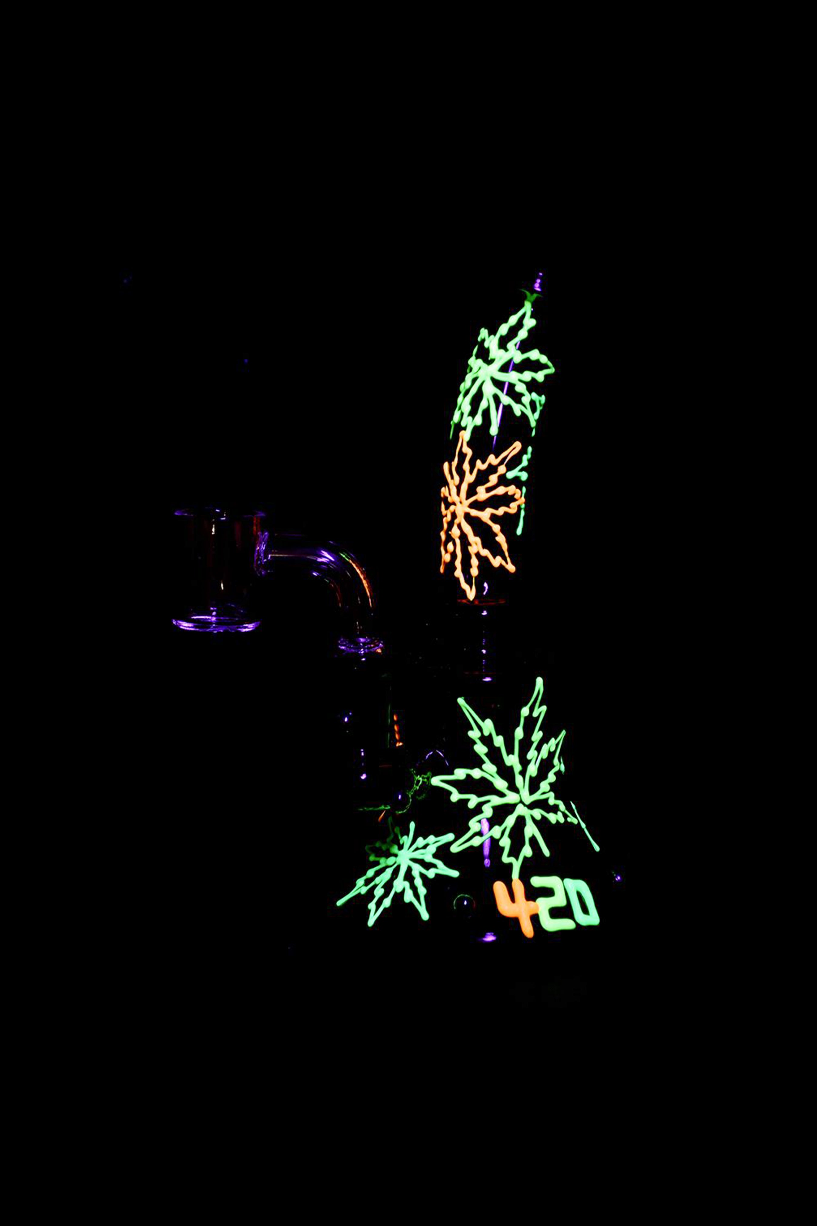 Glowing cannabis leaves and a smoking device illuminated in a dark setting, with "420" displayed below.