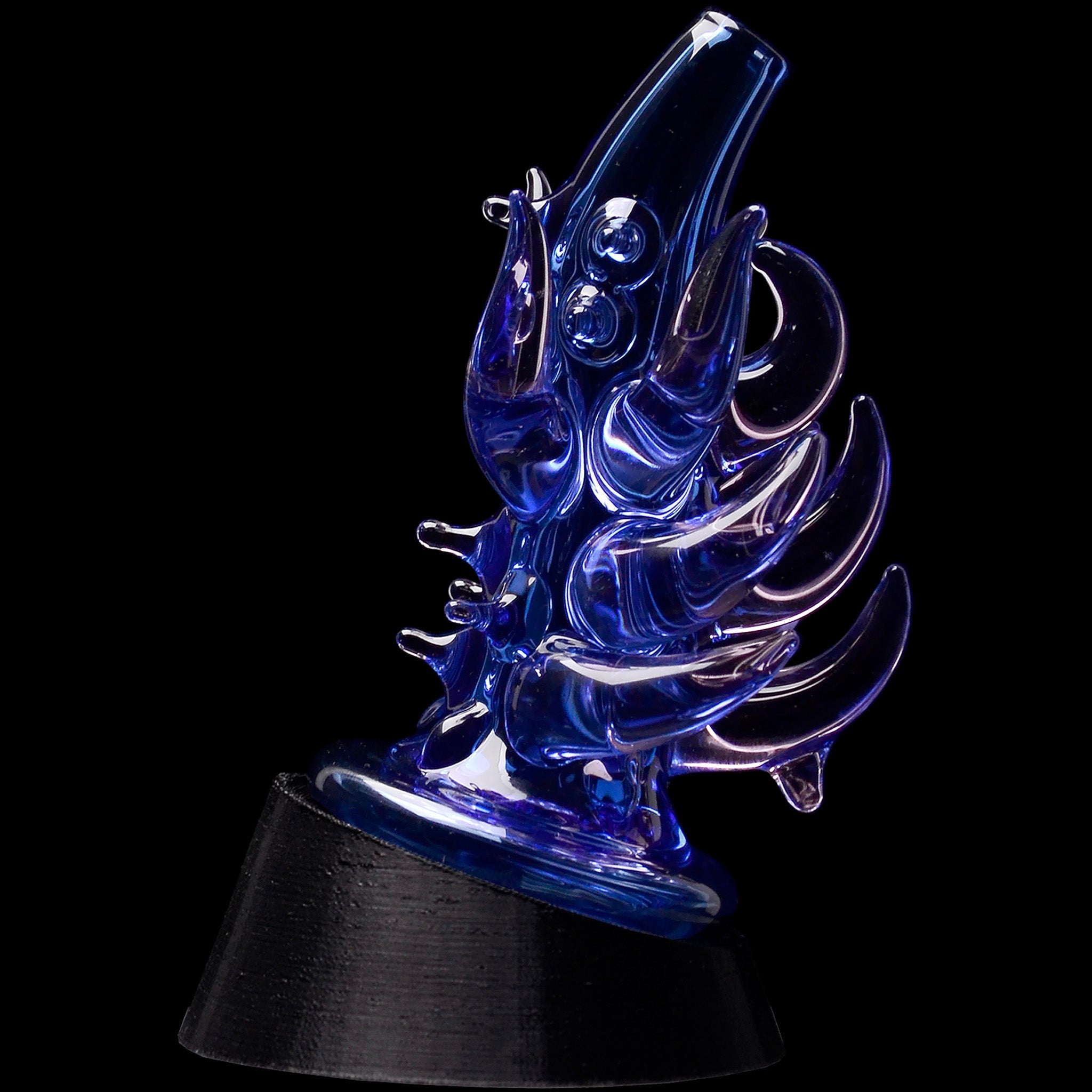 Close-up, angled view of the Glassic Cosmic Tentacle Puffco Peak Glass Attachment showing iridescent yellow-blue glass tentacles against a black background