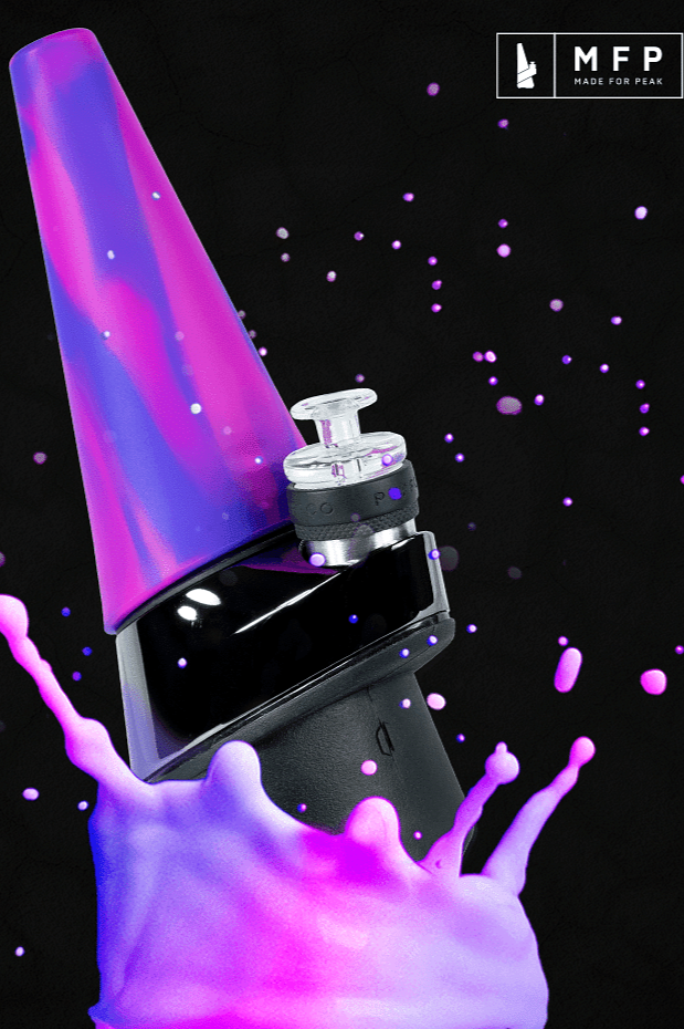 Purple cannabis concentrate vaporizes from a black electronic dab rig, with splashes and particles surrounding it.