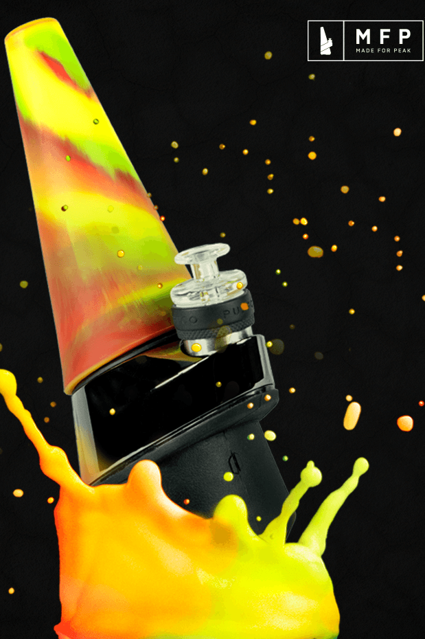 Colorful glass dab rig with a black electronic nail, splashed with golden liquid against a dark background.