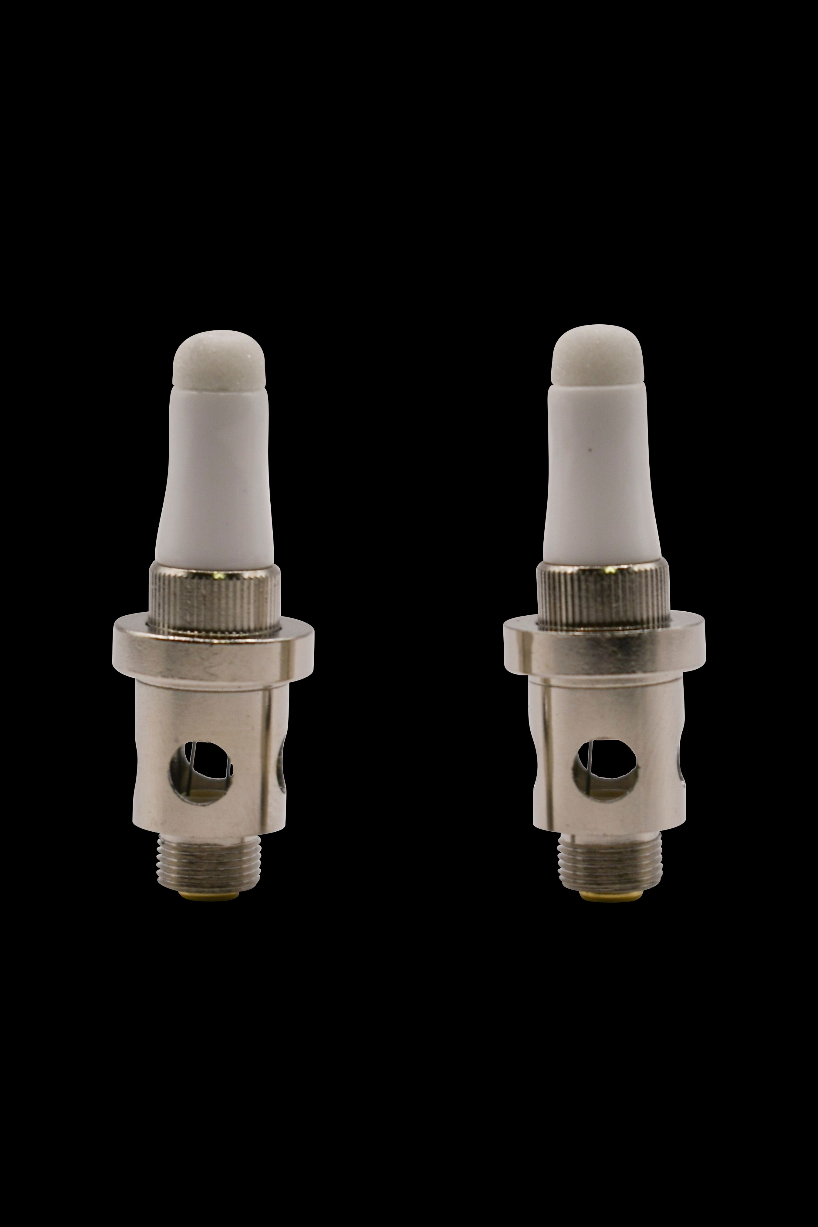 Two ceramic cannabis vape coil tips against a black background.