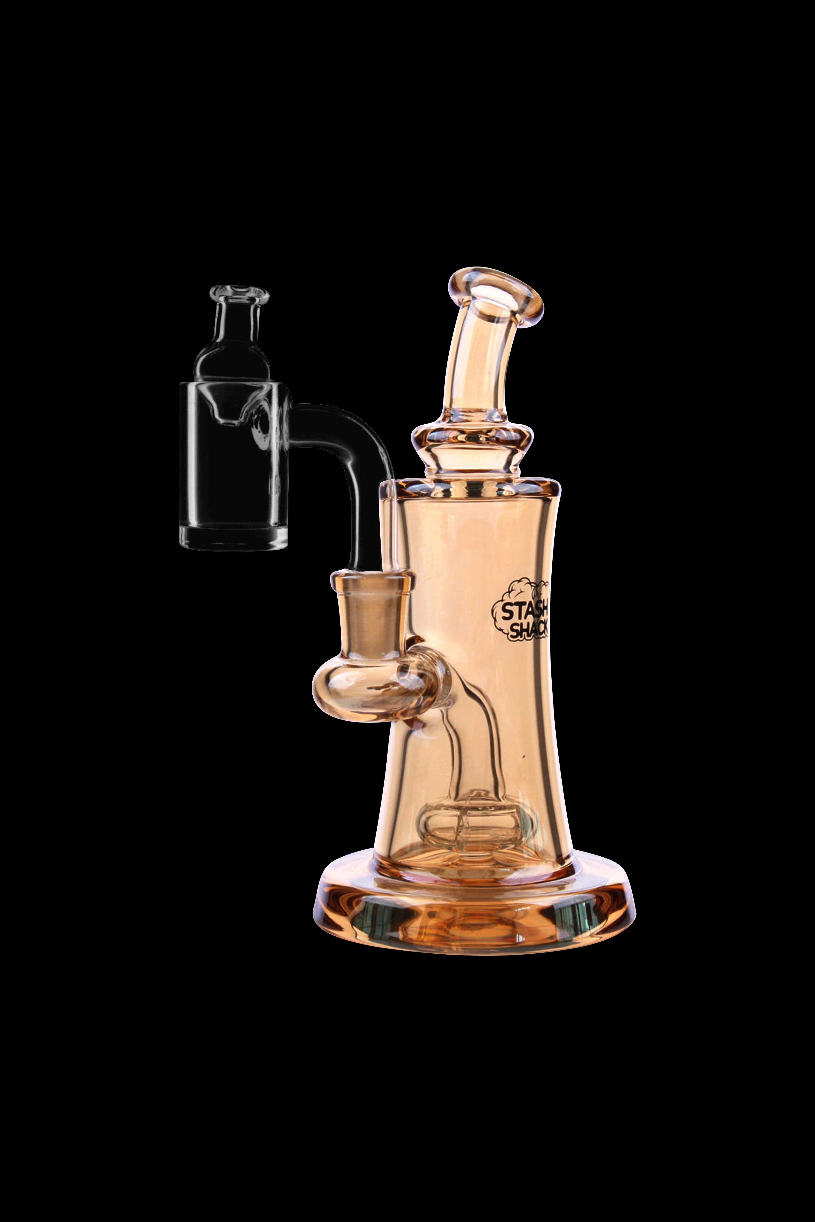 Amber glass dab rig with quartz banger, studio shot on black background.