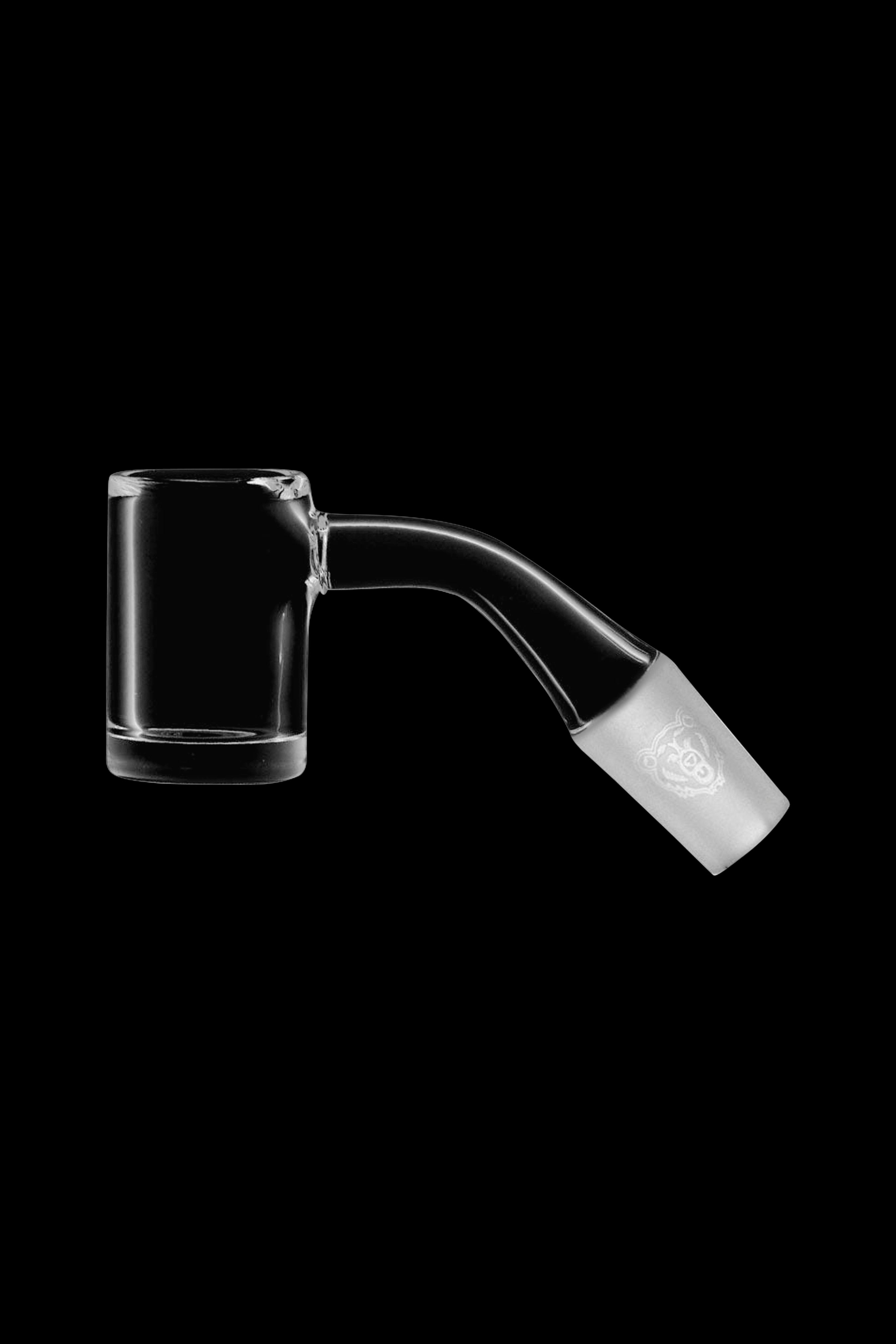 Clear quartz dab nail with etched logo, isolated on black.