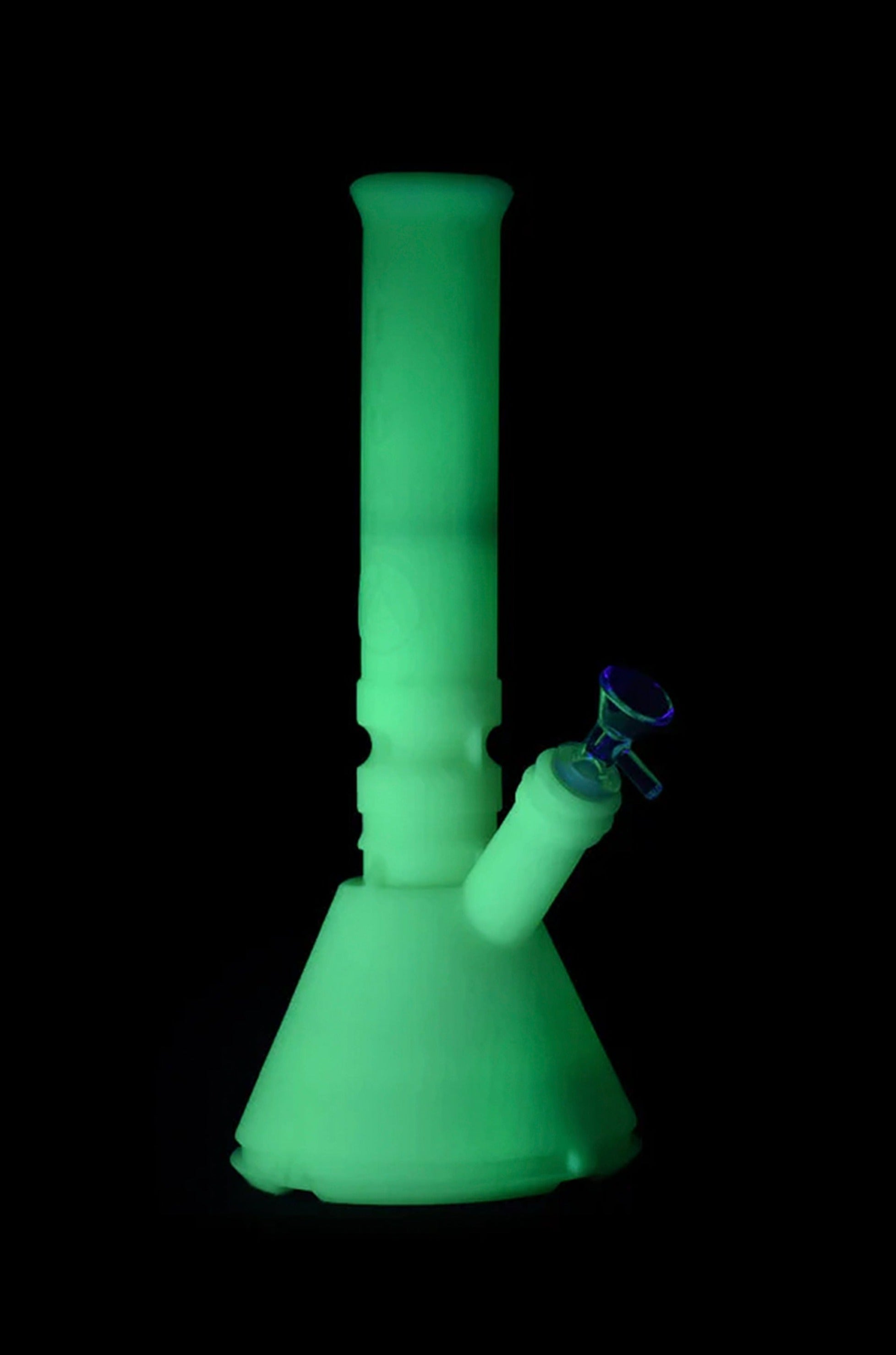 Glowing green glass bong isolated on black.