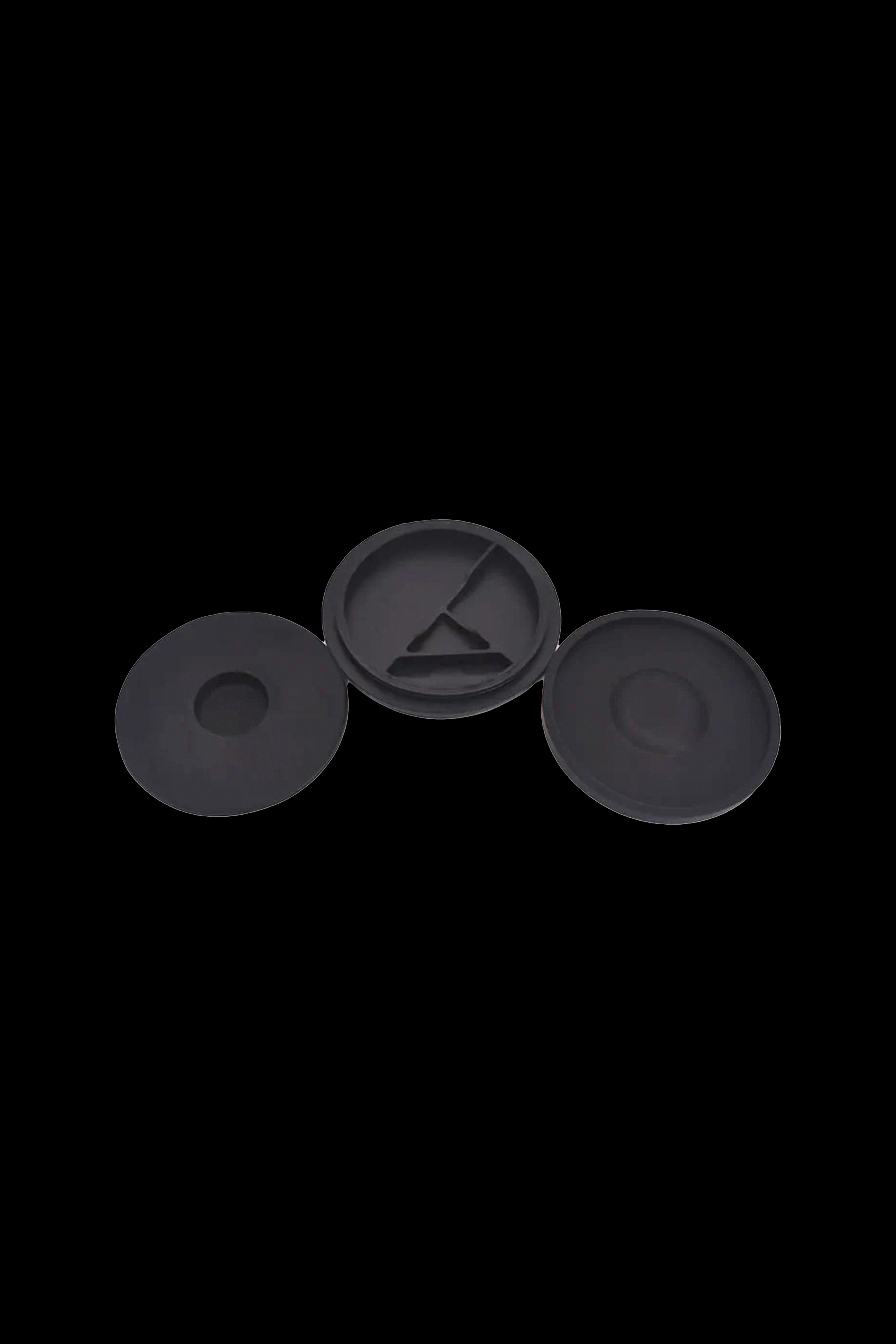 Three black silicone caps for cannabis oil cartridges.