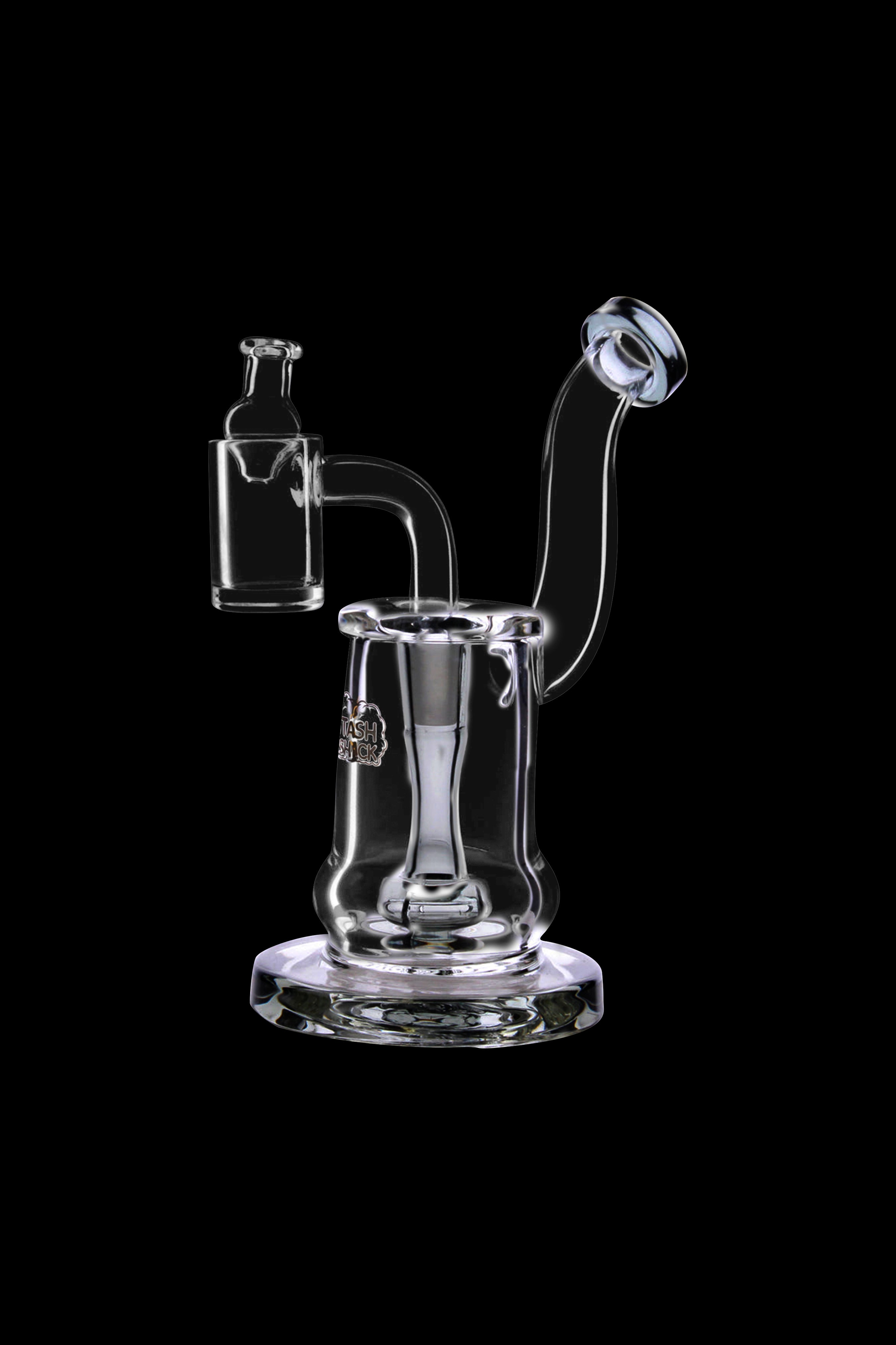 Clear glass dab rig with a quartz banger and intricate swirling design, isolated on a black background.