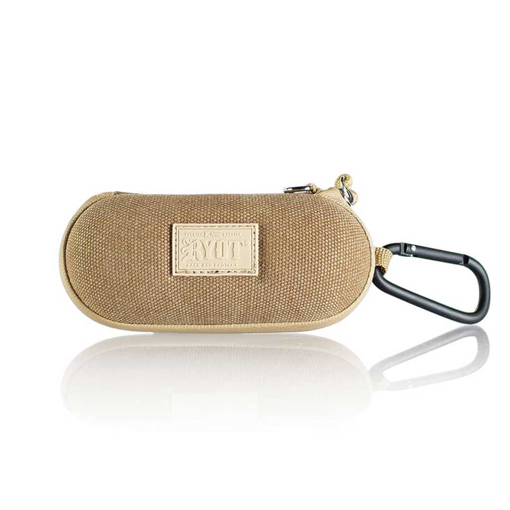 Front-facing shot of the tan RYOT Hardcase with textured fabric, stitched logo patch and attached black carabiner reflected on a white surface