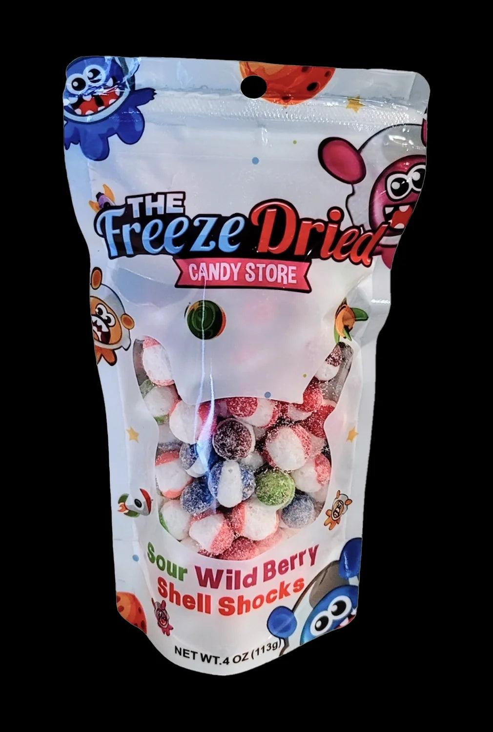 A colorful, sealed plastic bag labeled "The Freeze Dried Candy Store" and "Sour Wild Berry Shell Shocks" containing colorful, freeze-dried candies, likely cannabis-infused edibles.