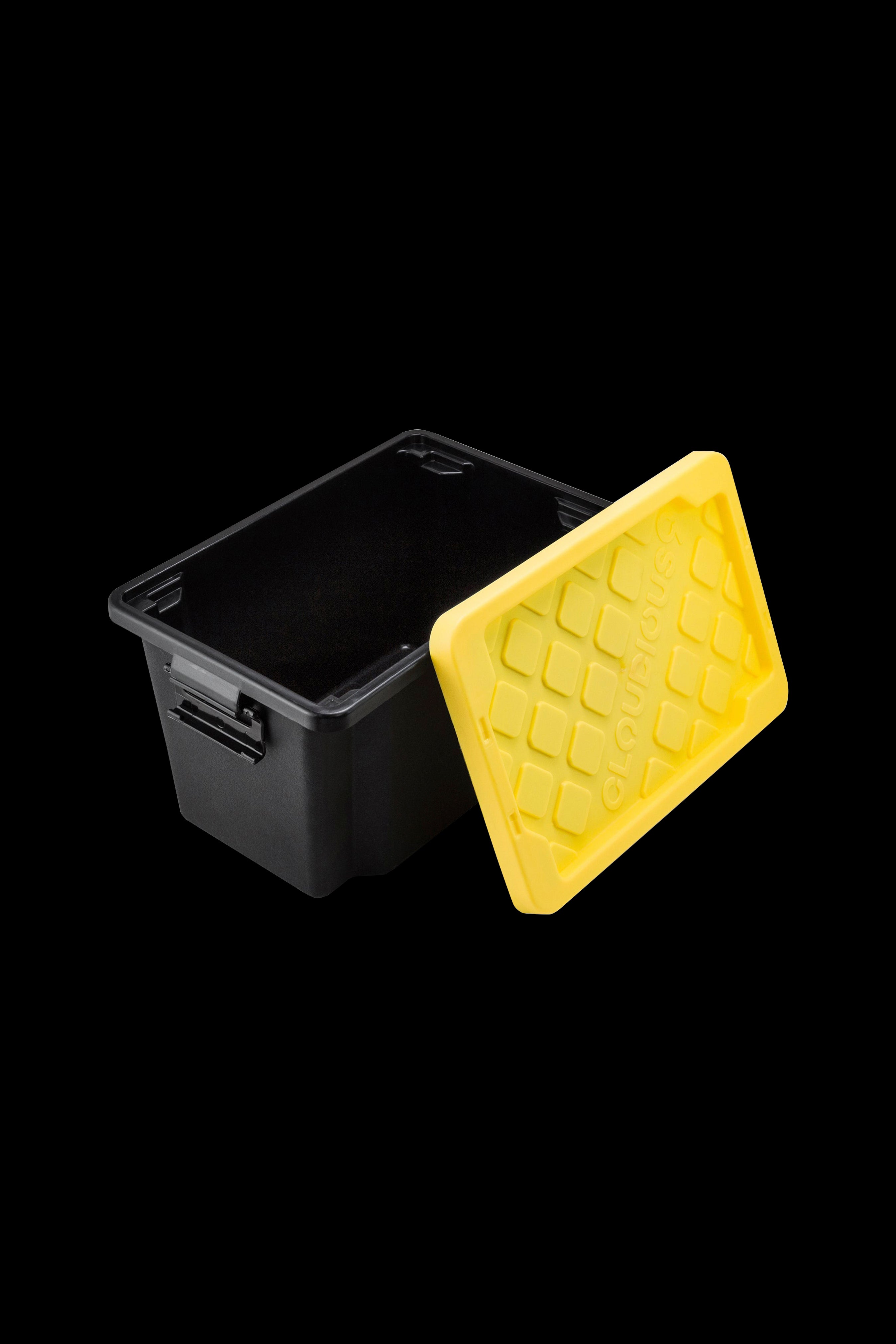 Black smell-proof container with a yellow honeycomb-patterned silicone lid, open and floating above.