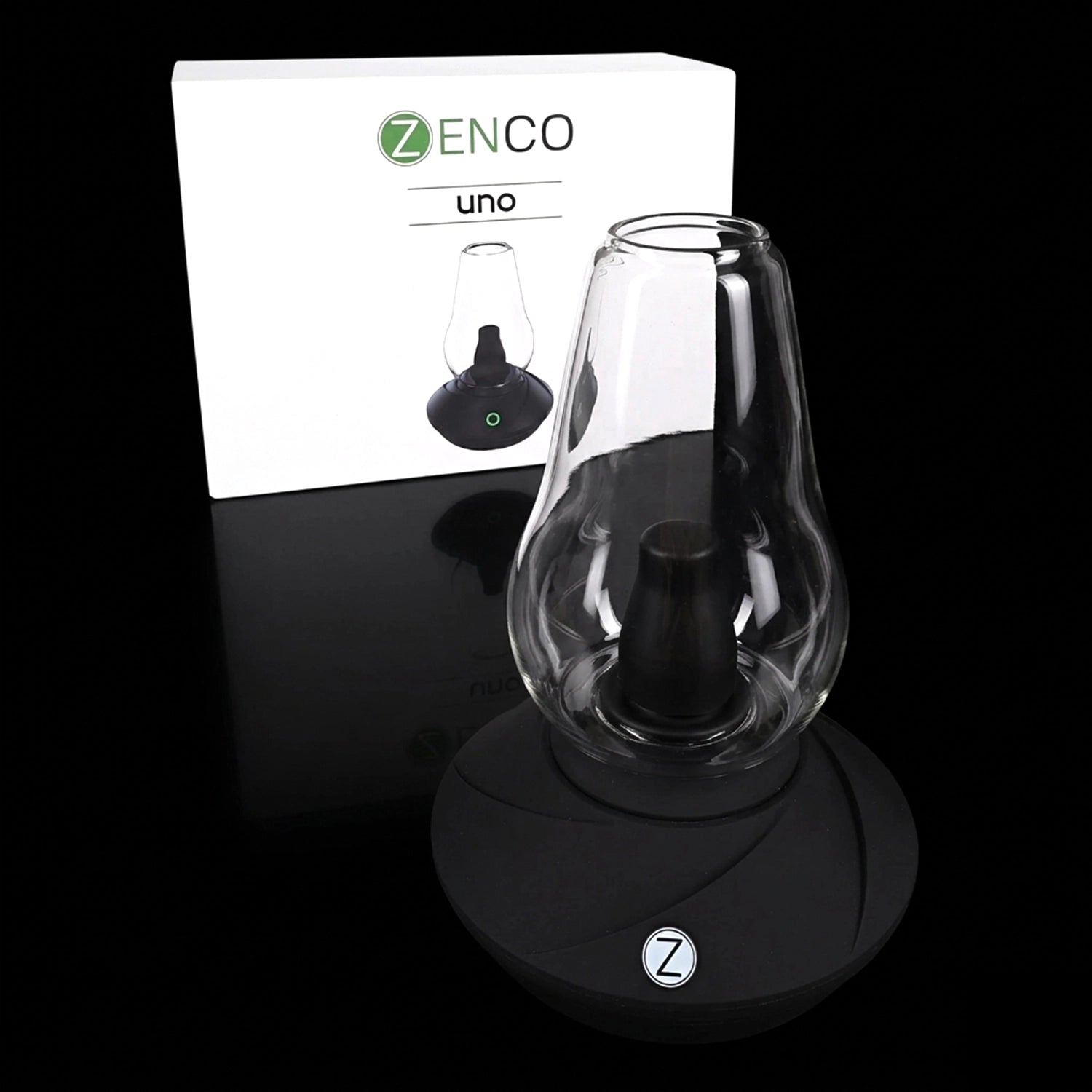 Close-up front view of the Zenco Uno Desktop Vaporizer on a glossy black surface with its white branded box in the background