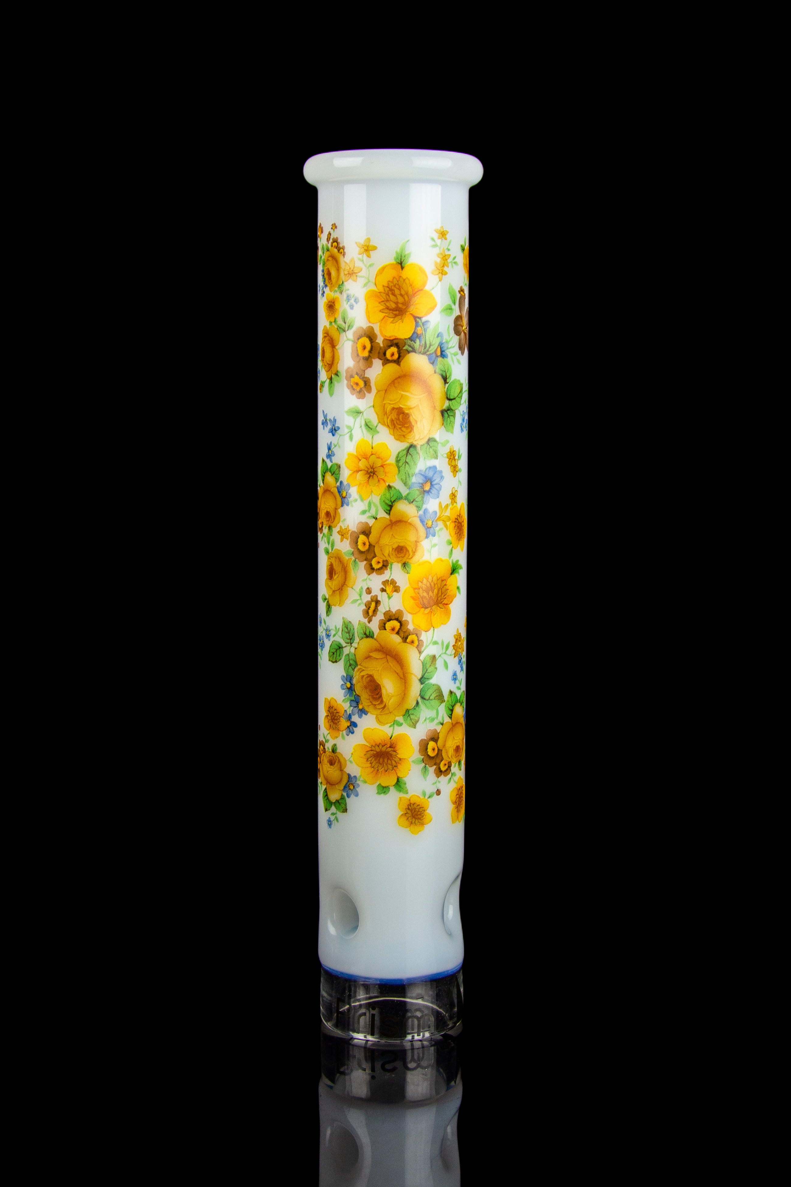 Floral glass pipe reflecting on a dark surface.