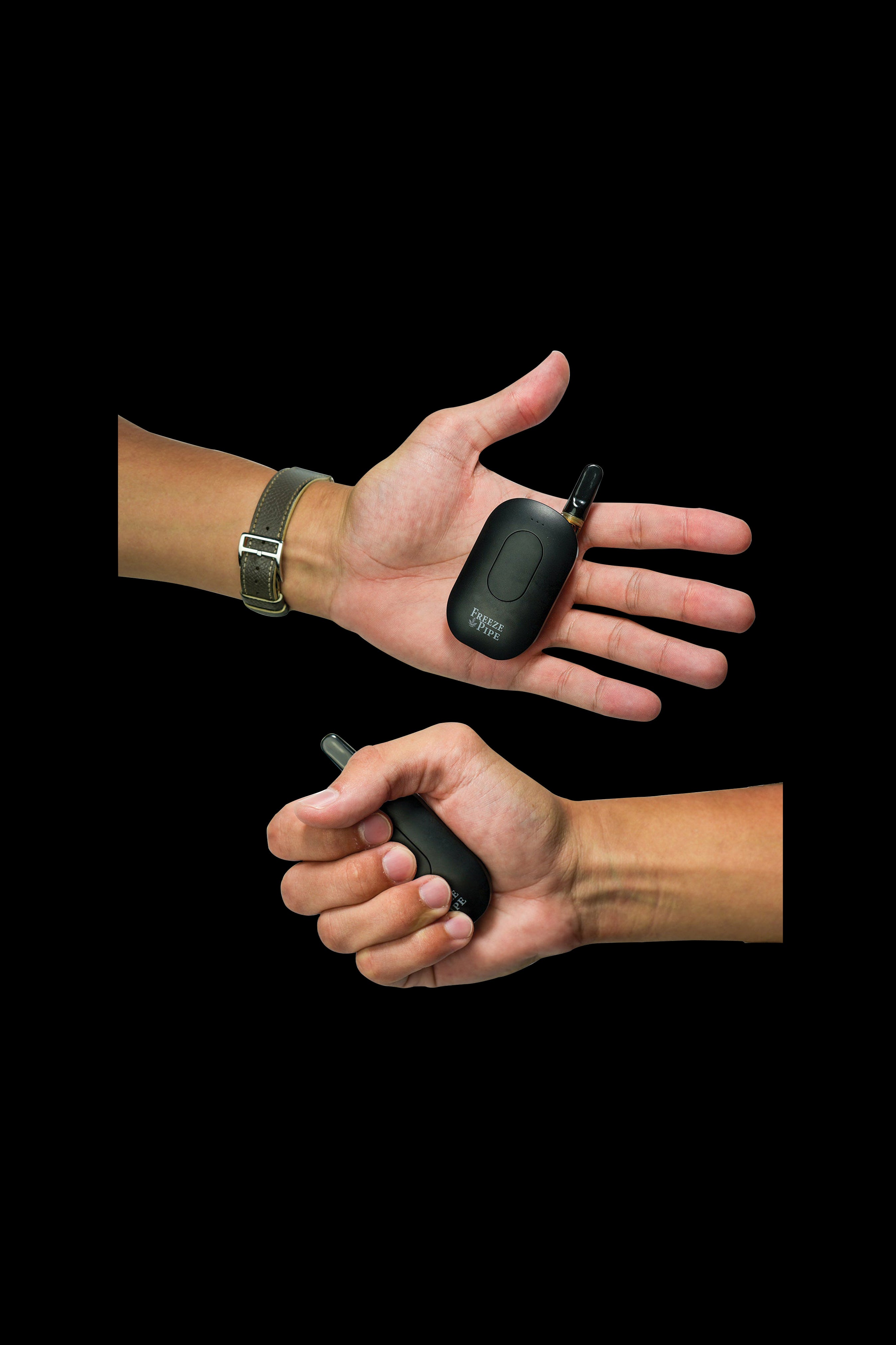 Two hands holding sleek, black cannabis vaping devices against a dark background.