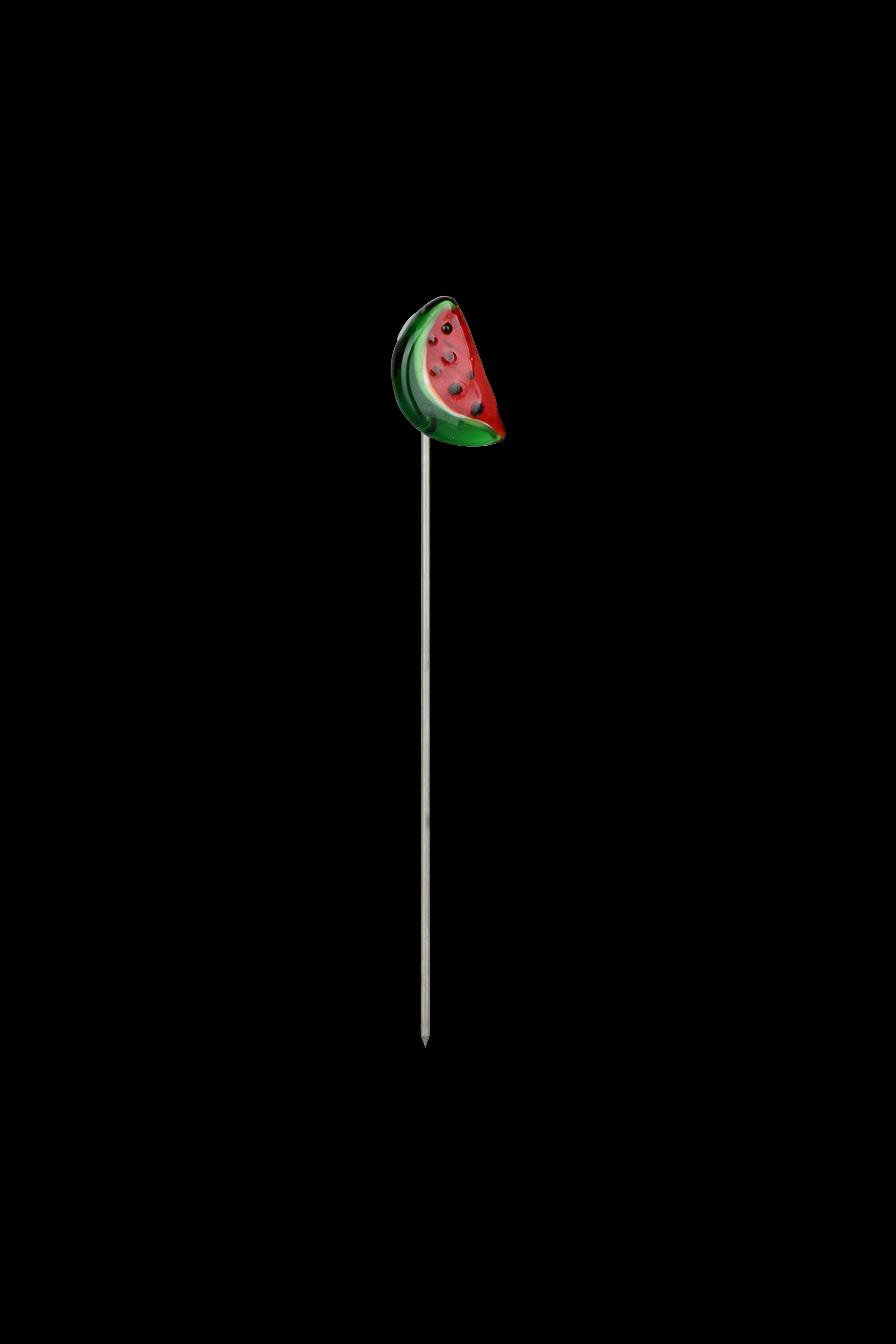 Watermelon-shaped dab tool with a long, thin metal tip on a black background.