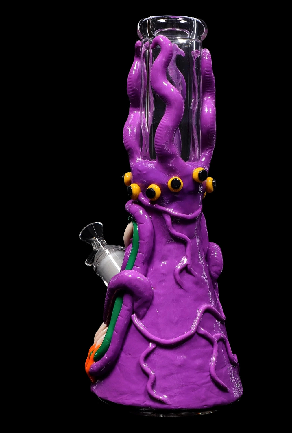 Purple glass water pipe shaped like an octopus with multiple eyes, against a black background.