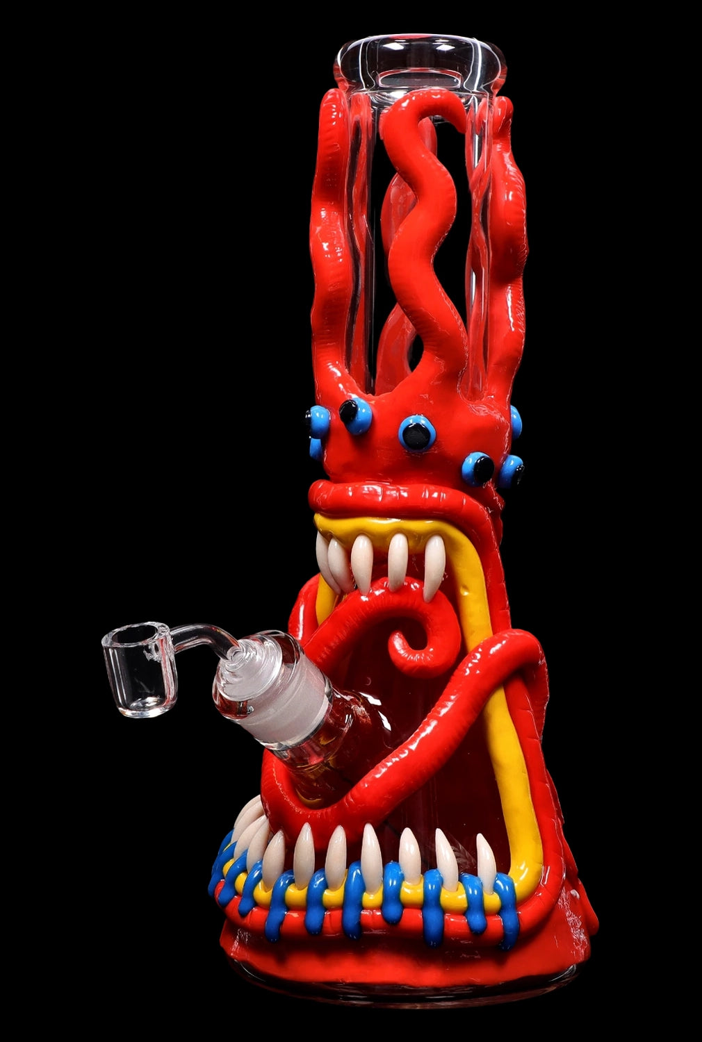 Red glass bong shaped like a monster with large teeth and googly eyes.