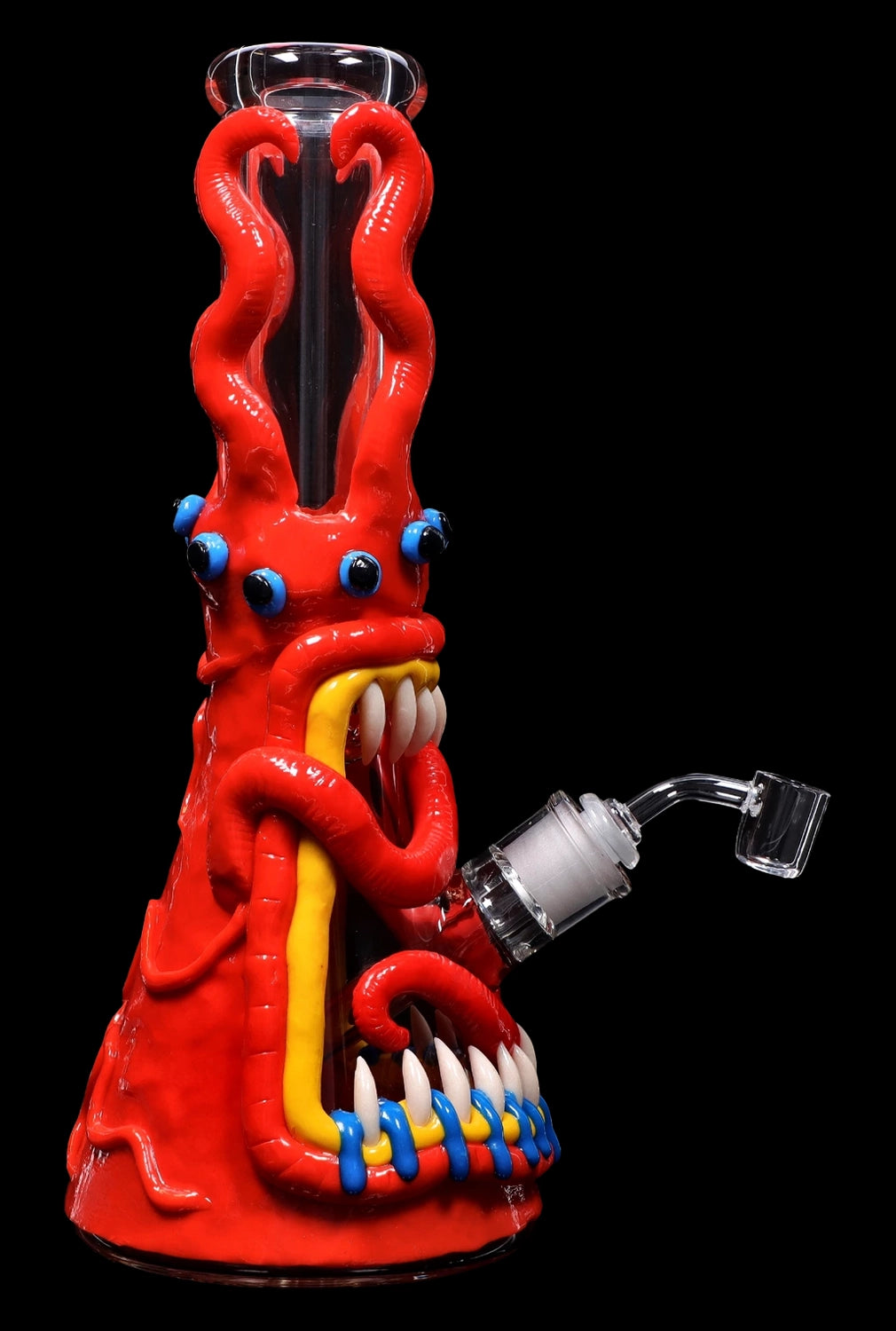 A vibrant red glass bong shaped like a cartoon monster with blue eyes, sharp teeth, and clawed feet, featuring a clear glass bowl.