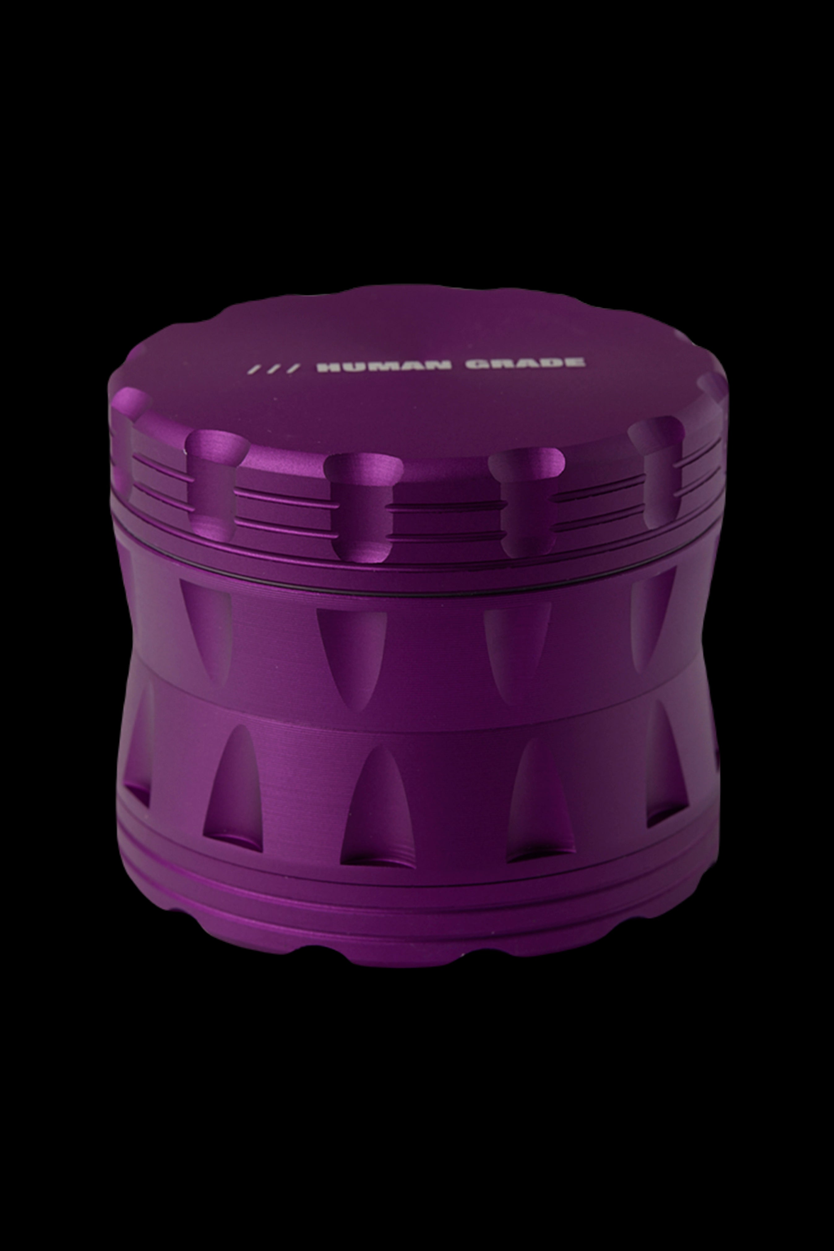 Purple cannabis grinder with “HUMAN GRADE” text.