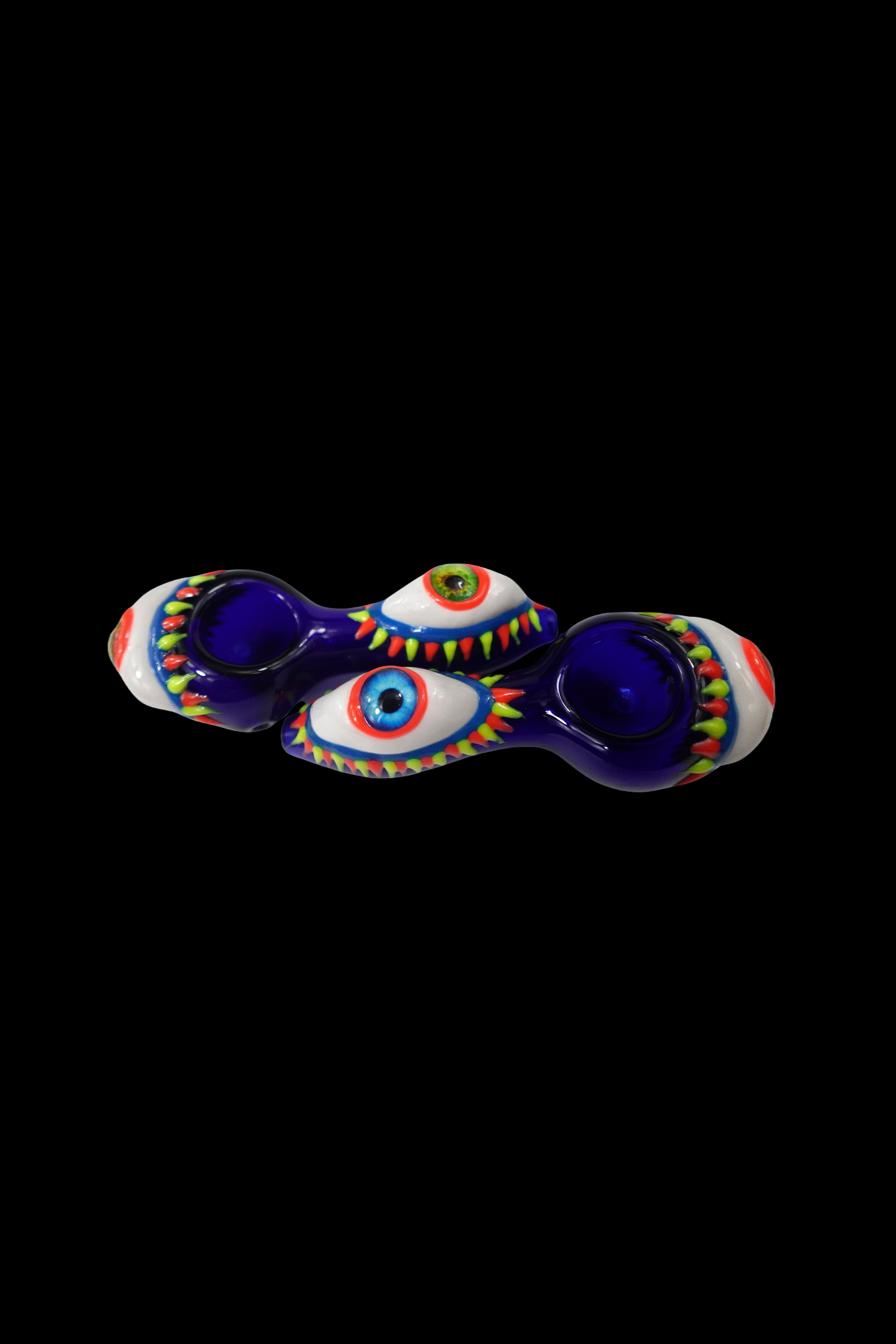 Hand-blown glass pipe shaped like two eyes with colorful detailing, isolated on a black background.