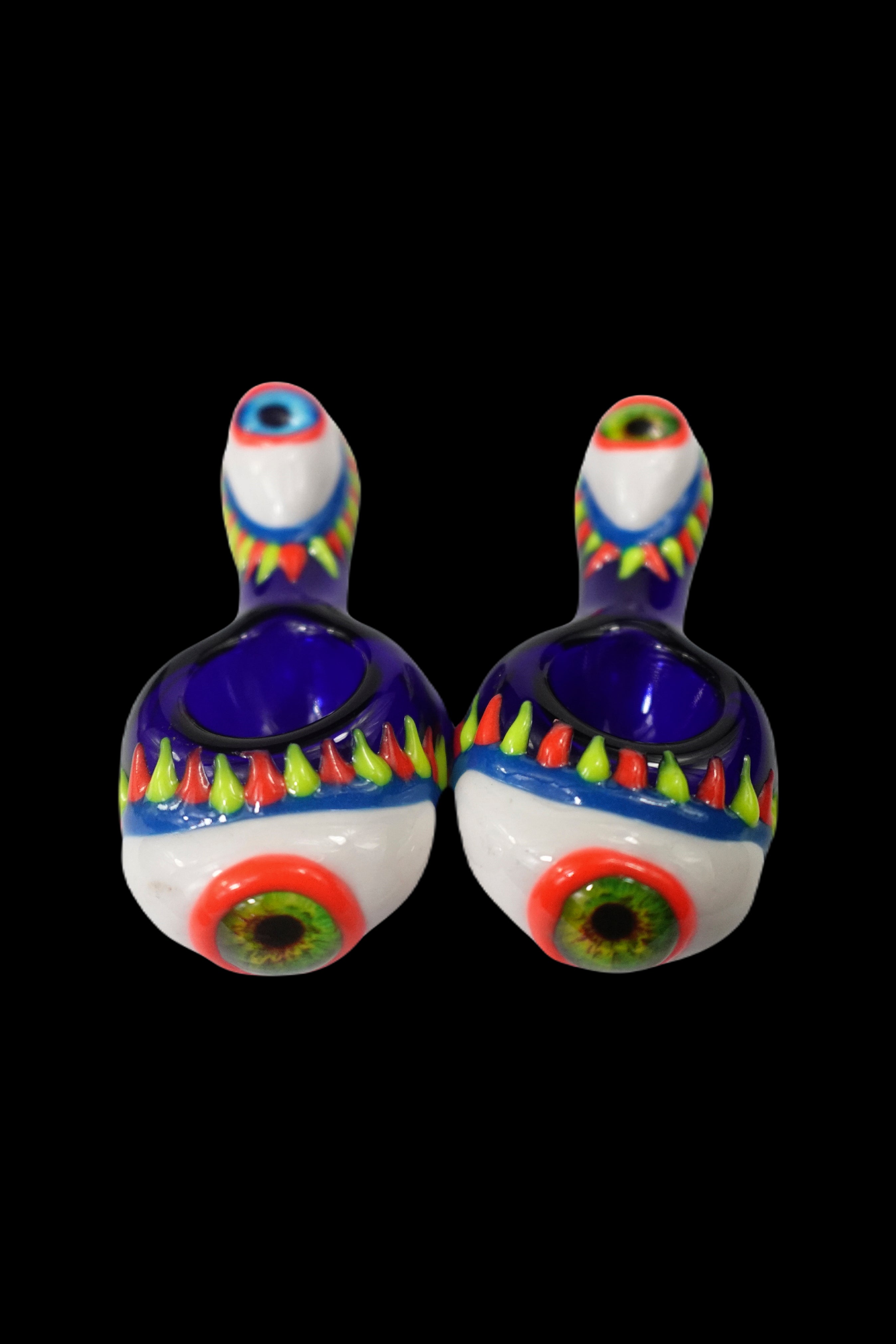 Two colorful glass pipes resembling eyes with intricate designs, isolated on a black background.