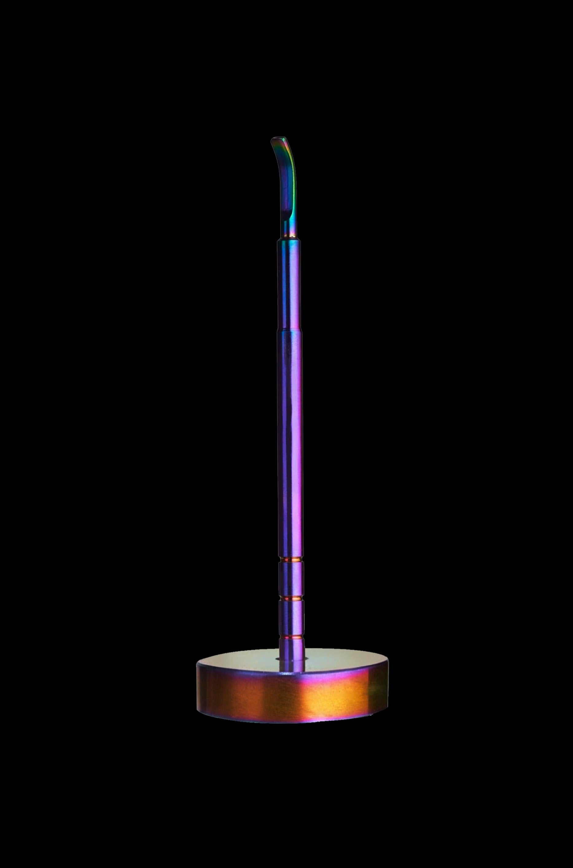 Iridescent cannabis oil applicator on a black background.
