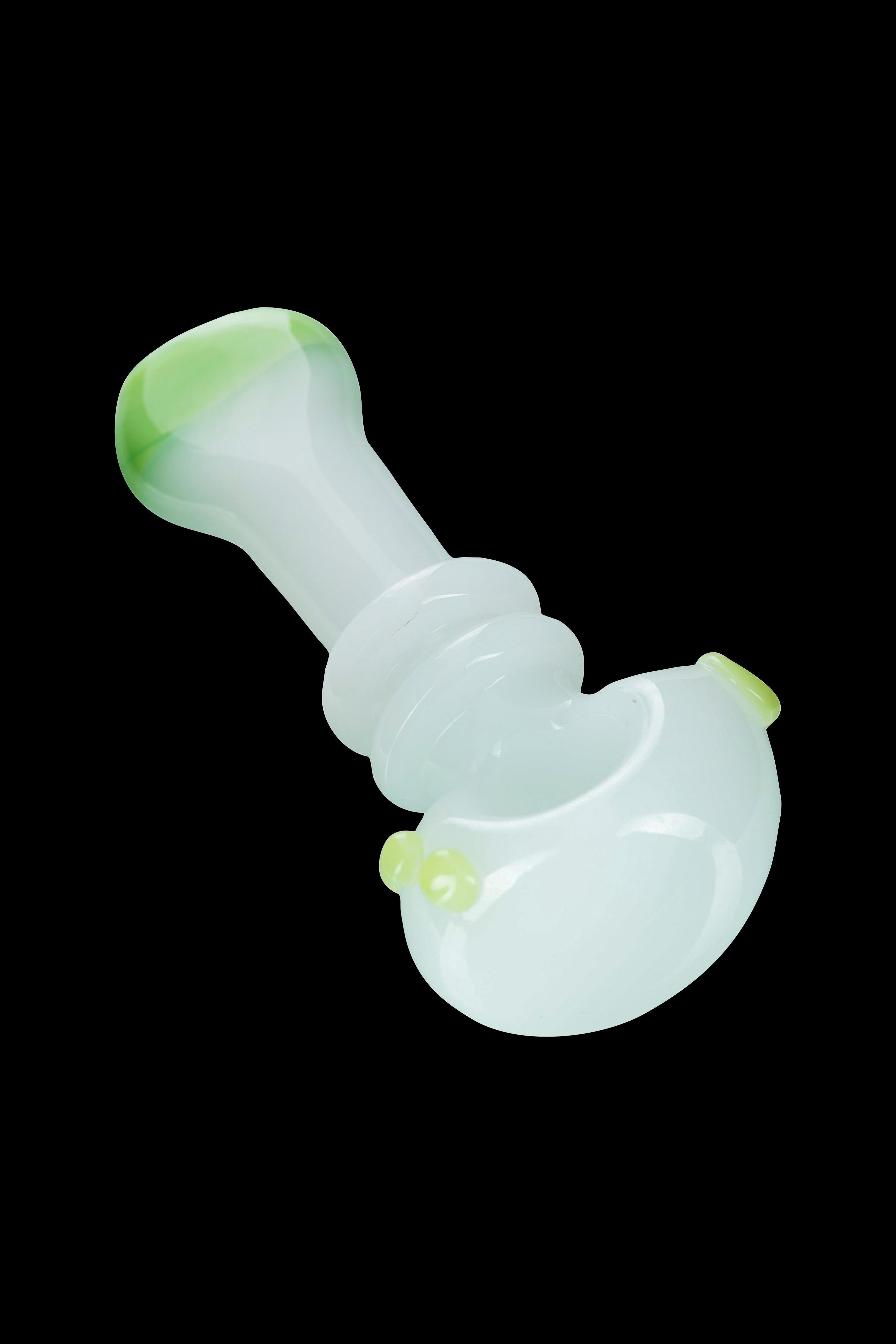Pale green glass pipe for smoking cannabis, isolated on a black background.