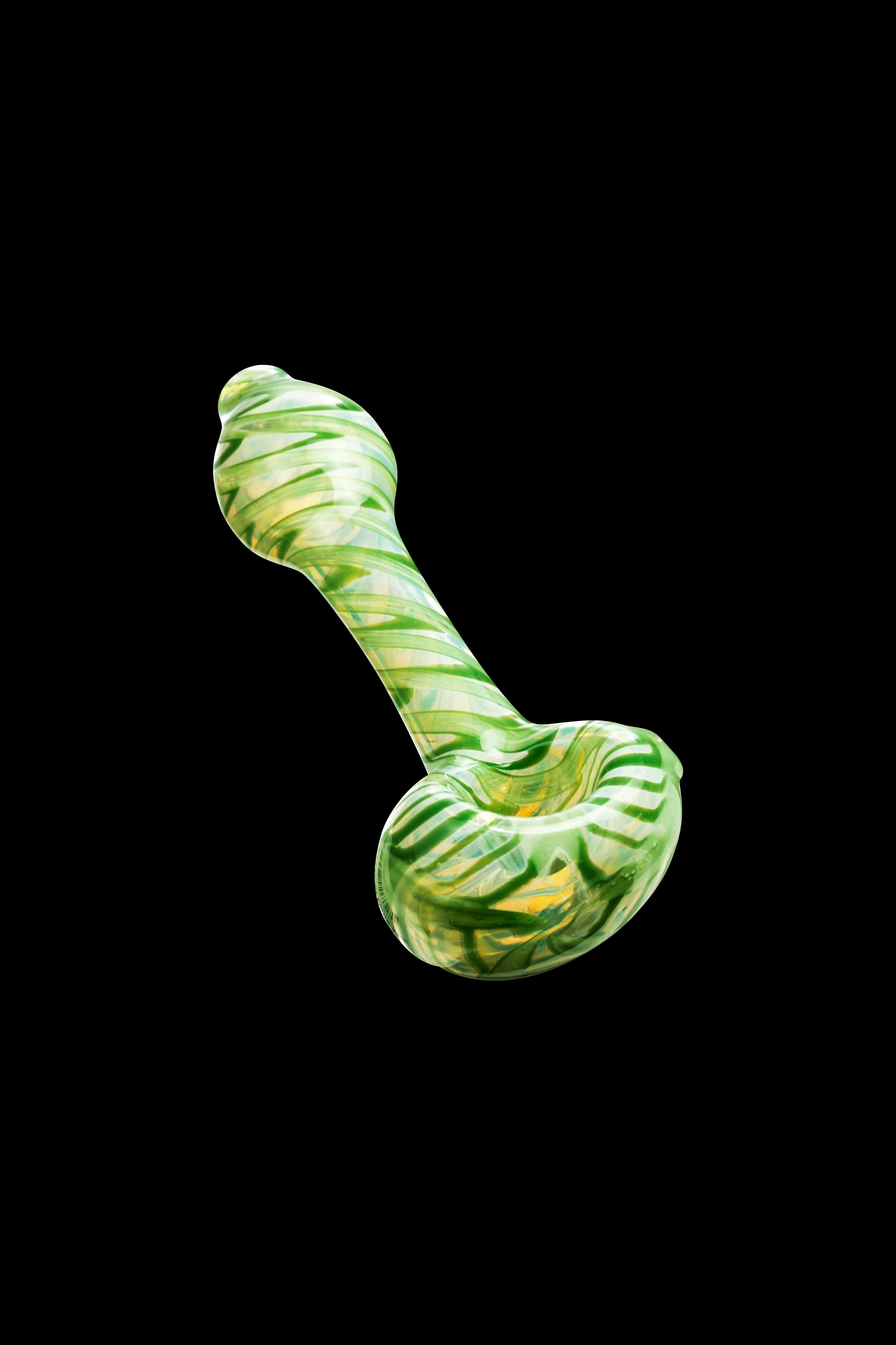 Green and white glass pipe isolated on a black background.