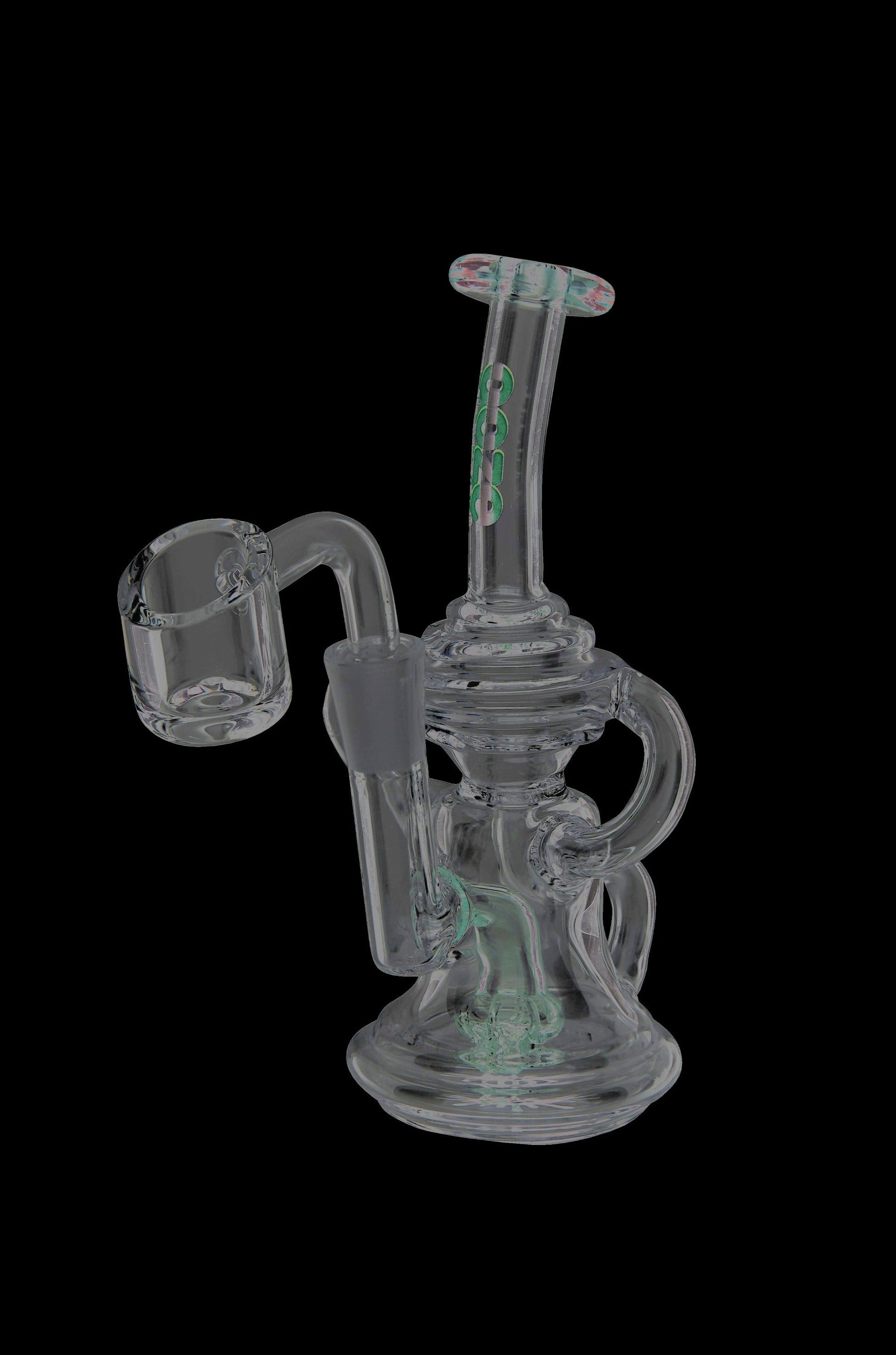 A translucent glass dab rig with green accents and a quartz banger, isolated on a black background.