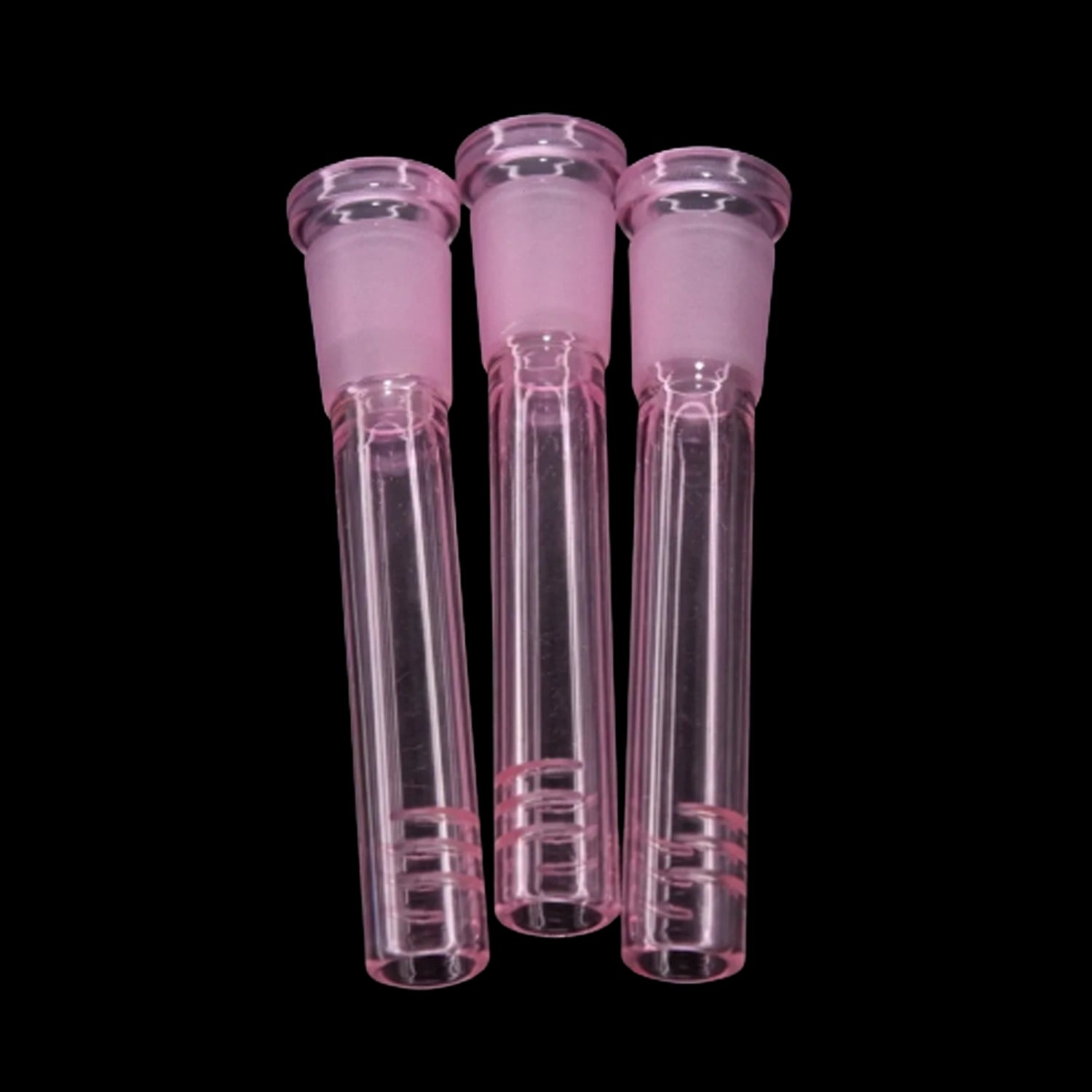 Close-up front view of three pink Smoke Cartel Color Diffused Downstem - 3 in. glass diffusers aligned vertically against a black background.