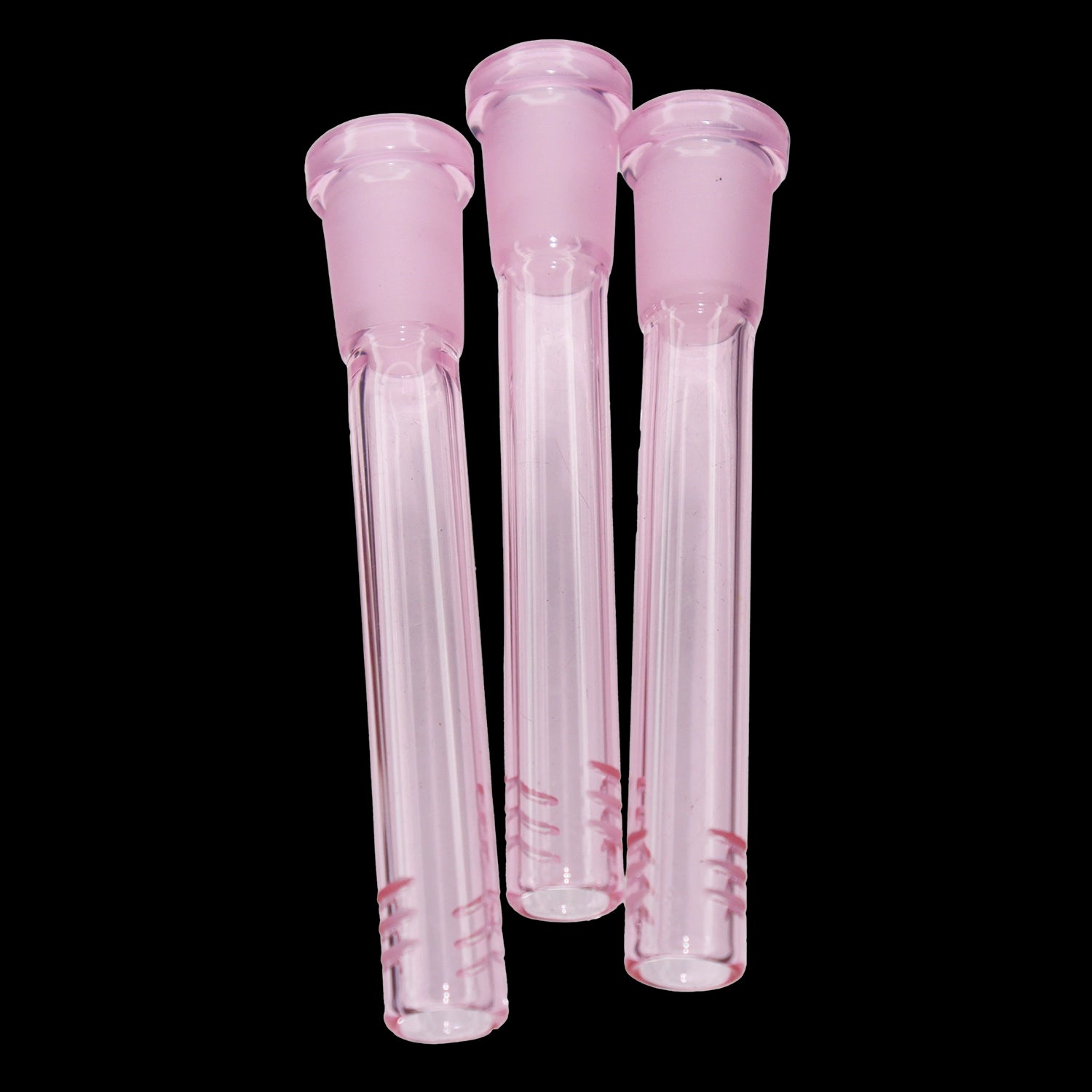 Close-up front view of three pink Smoke Cartel Color Diffused Downstem - 3.5 in. glass stems against a black background.