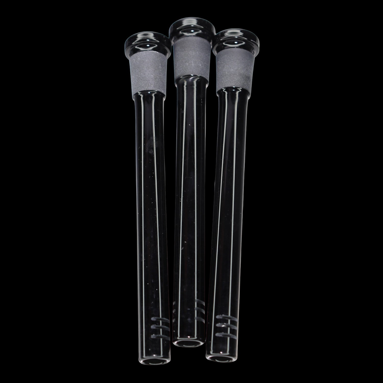 Close-up front view of three clear glass Smoke Cartel Color Diffused Downstem - 5 in. tubes with frosted joints, shown against a black background.