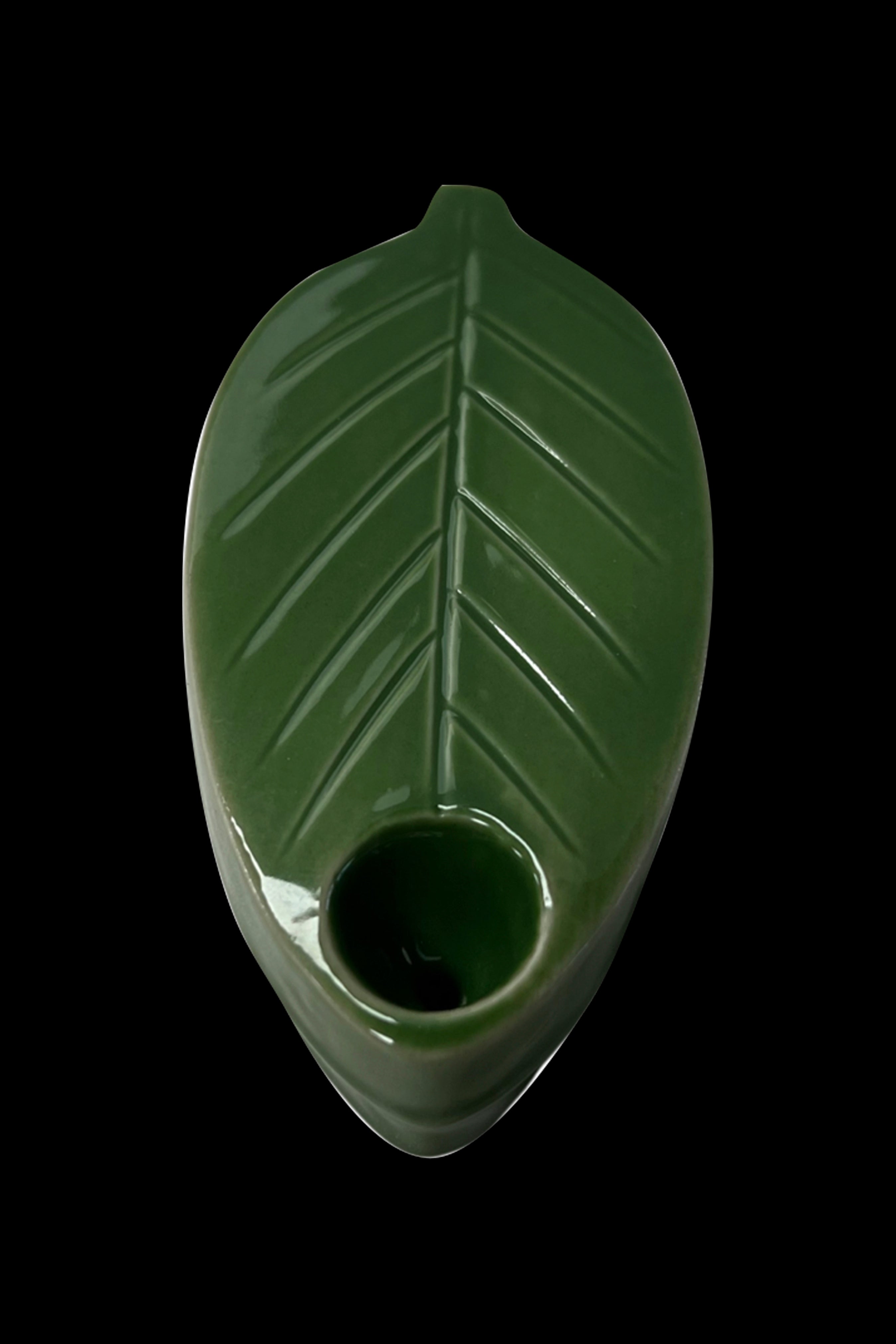 Green glass pipe shaped like a cannabis leaf.