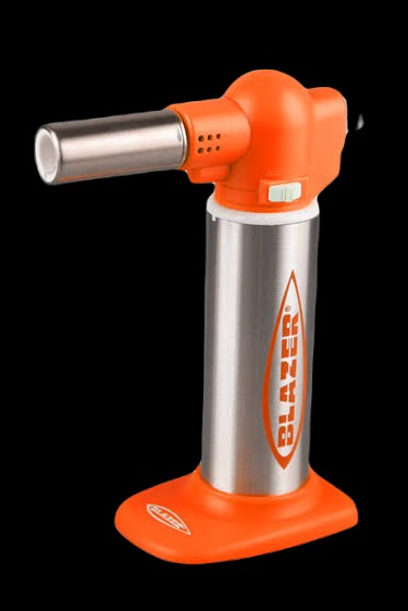 Orange and silver butane torch with flame, commonly used for dabbing cannabis concentrates.
