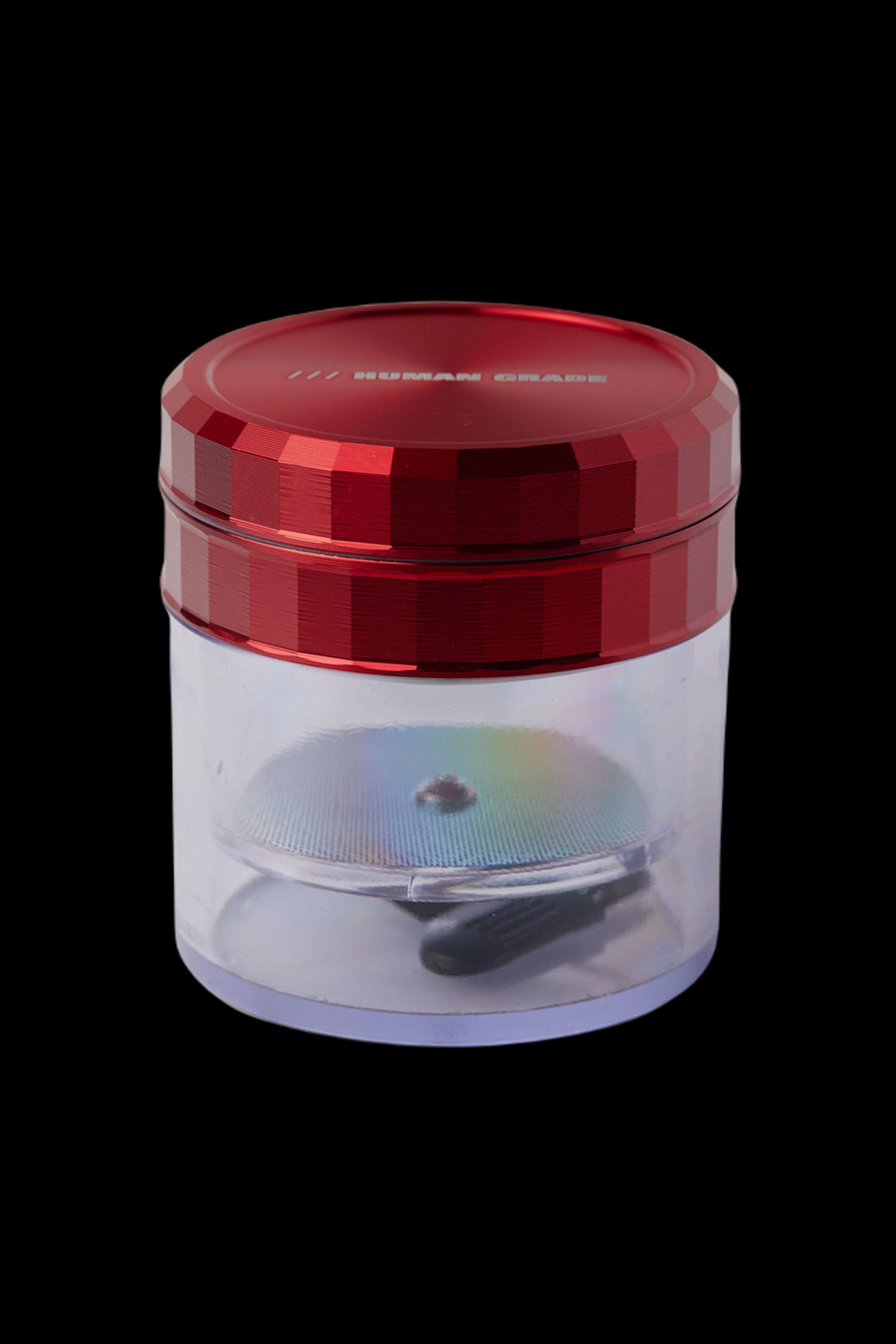 Red and clear cannabis grinder with visible ground material inside.