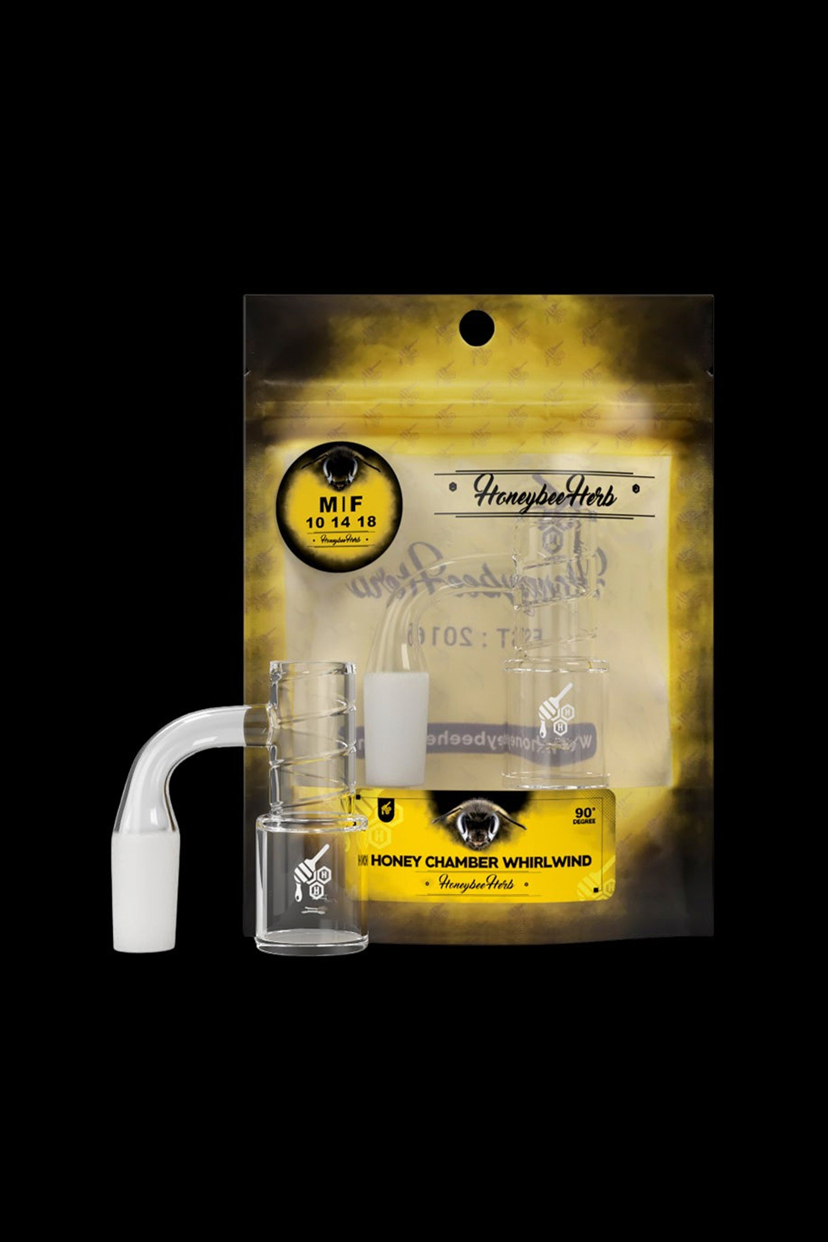 A sealed, gold foil bag of Honeybee Herbs cannabis accessories, featuring a clear quartz banger and carb cap for dabbing concentrates.