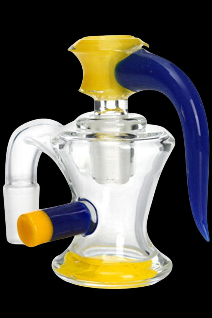 Clear glass dab rig with blue and yellow accents, featuring a bubbler design and angled mouthpiece.