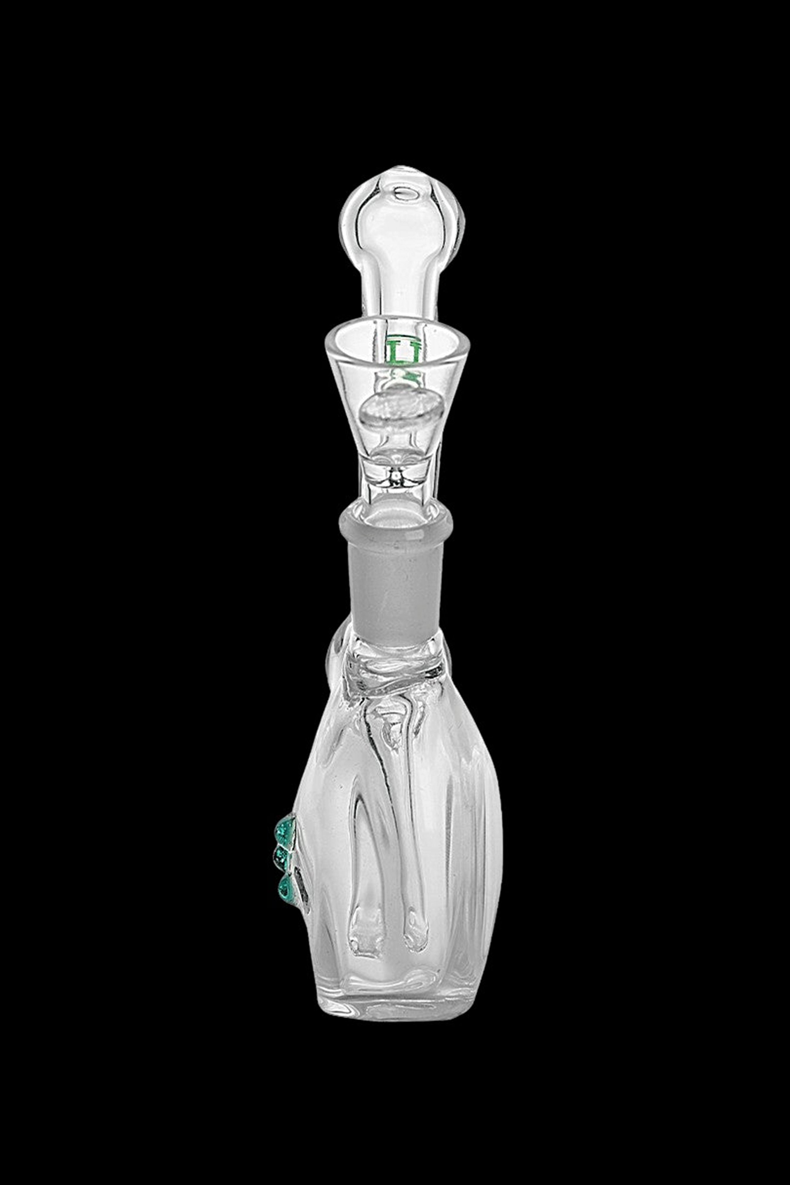 Clear glass dab rig with intricate sculpting and turquoise accents, isolated on a black background.