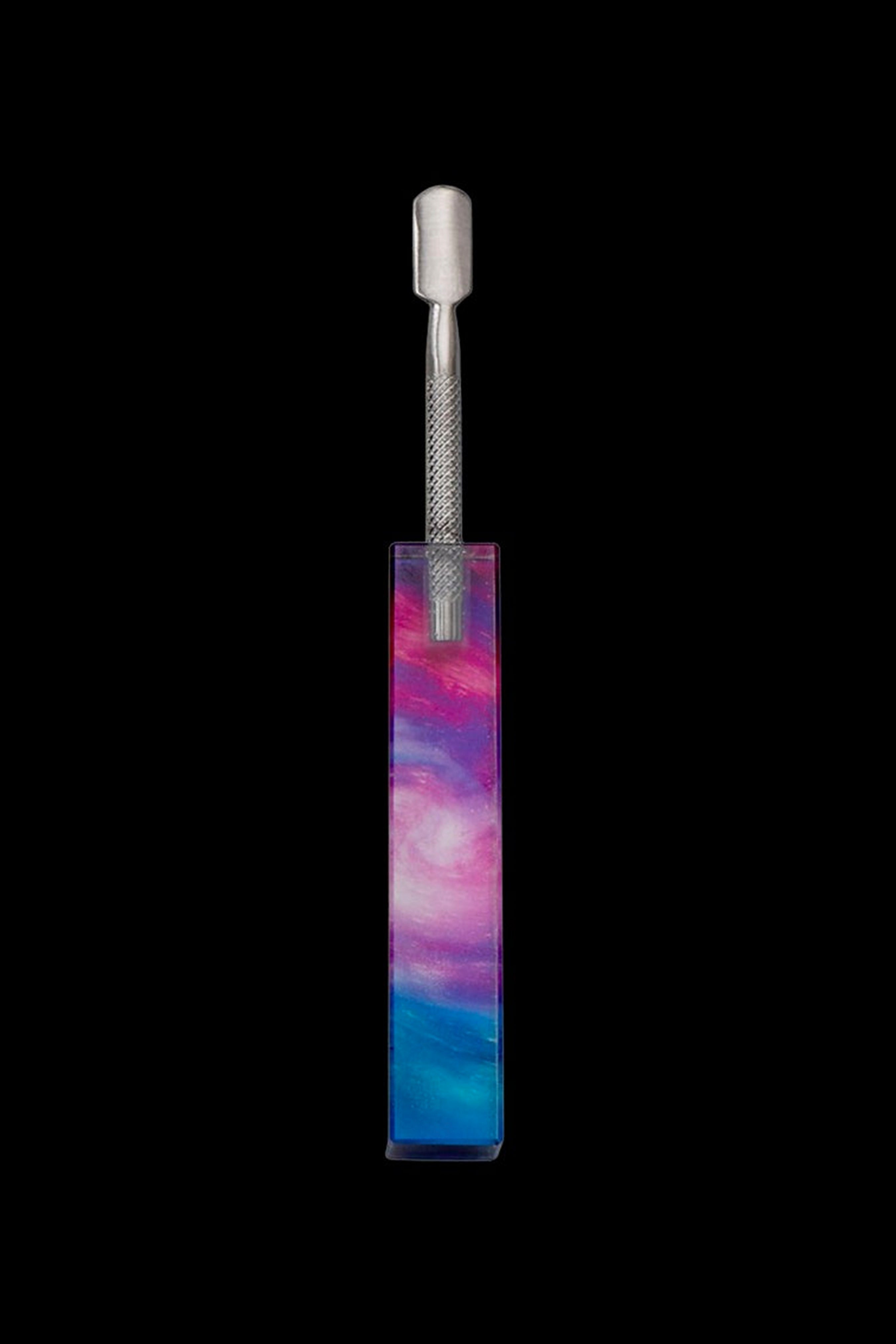 Cannabis dab tool in a colorful, nebula-patterned case against a black background.