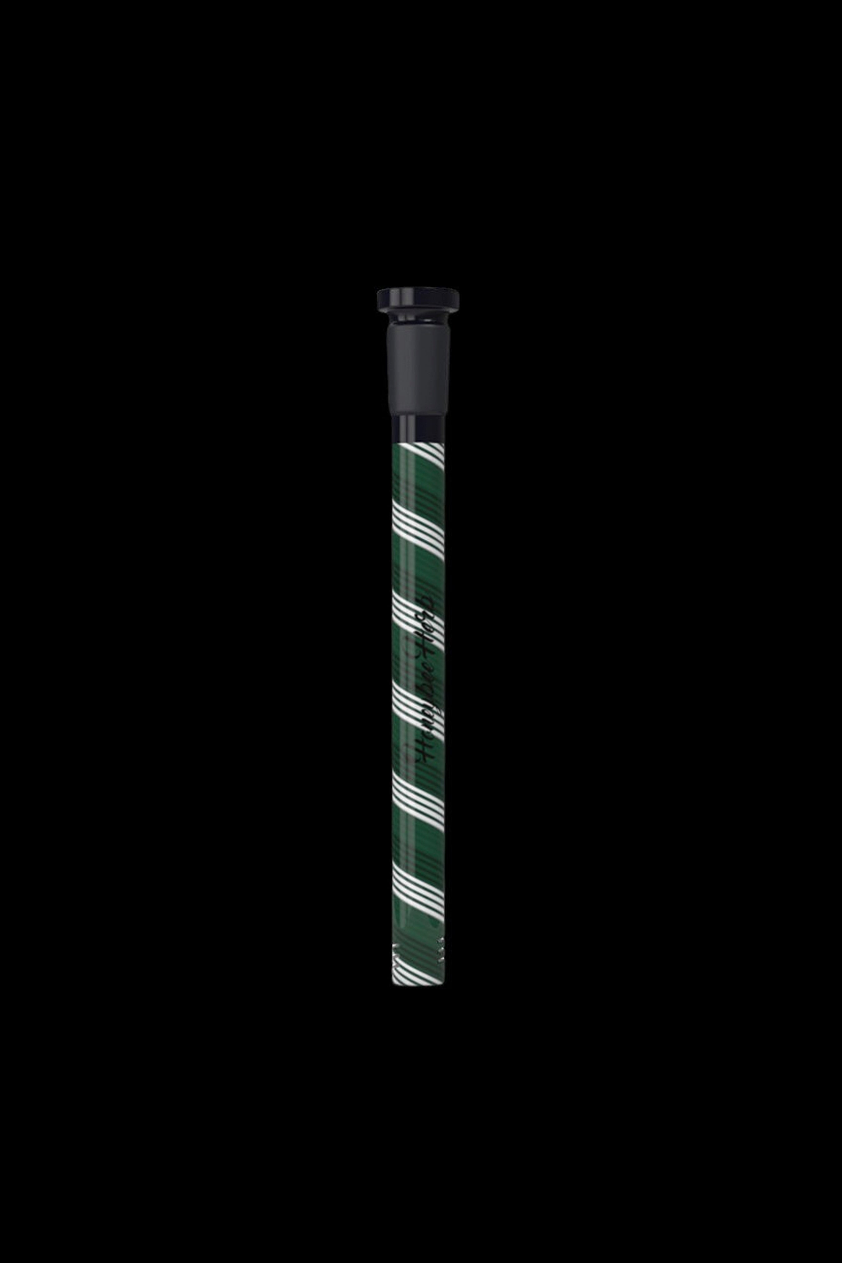 Glass pipe with green and white striped pattern against a black background.