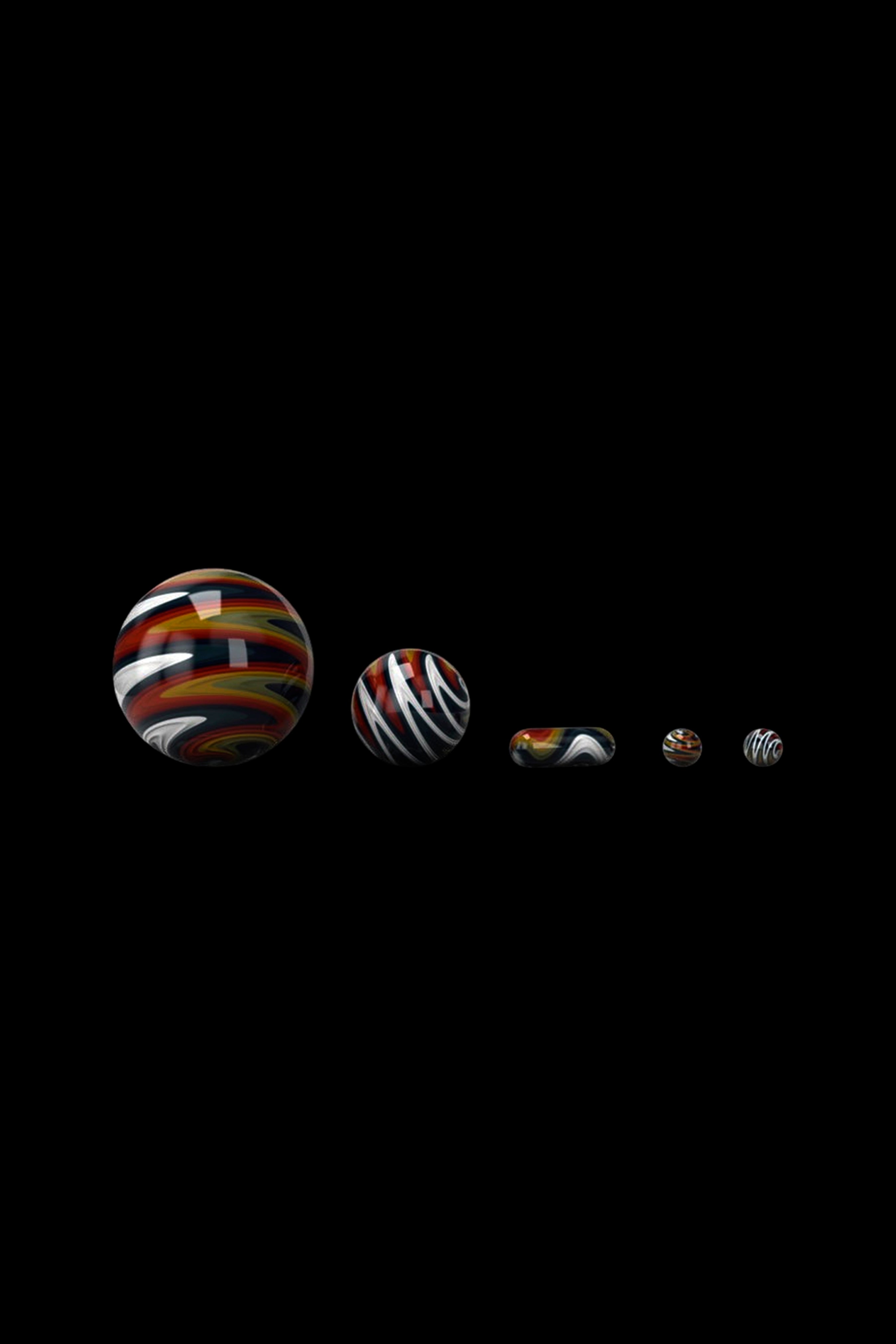 Glass marbles with swirling red, brown, and cream patterns against a black background.