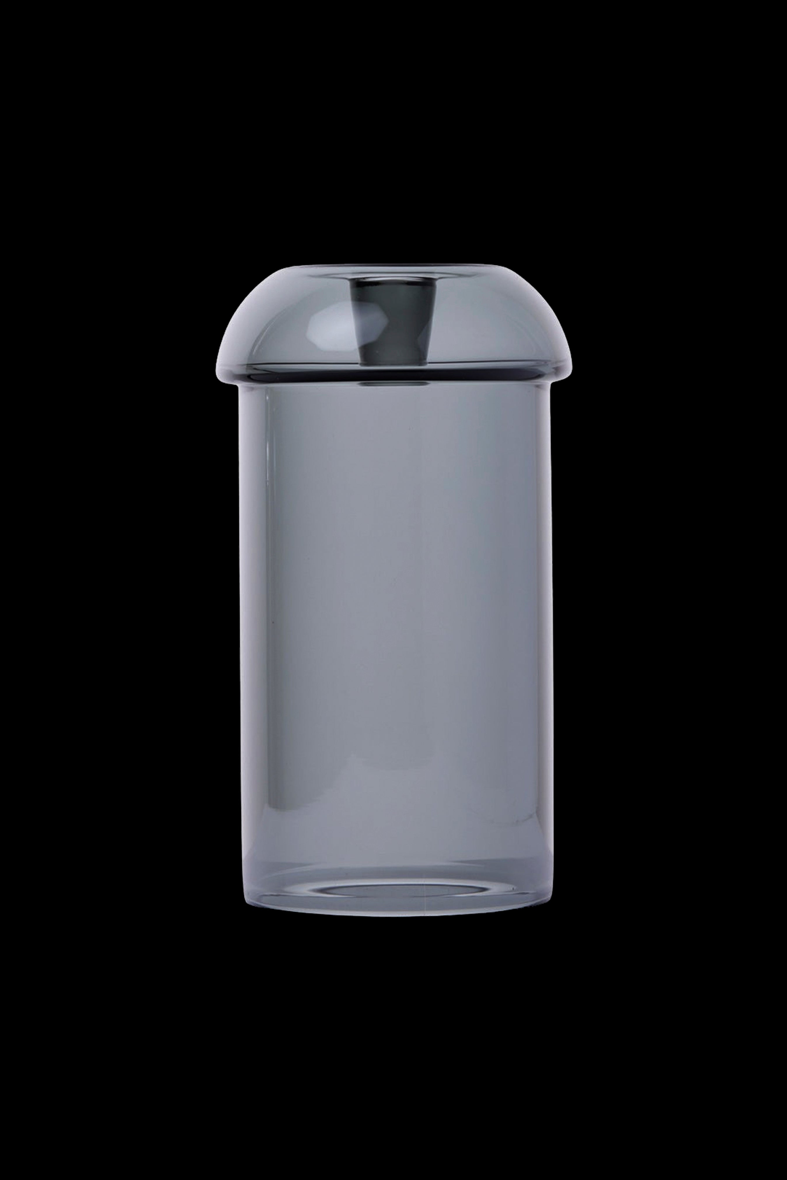 Clear glass bubbler water pipe isolated on a black background.