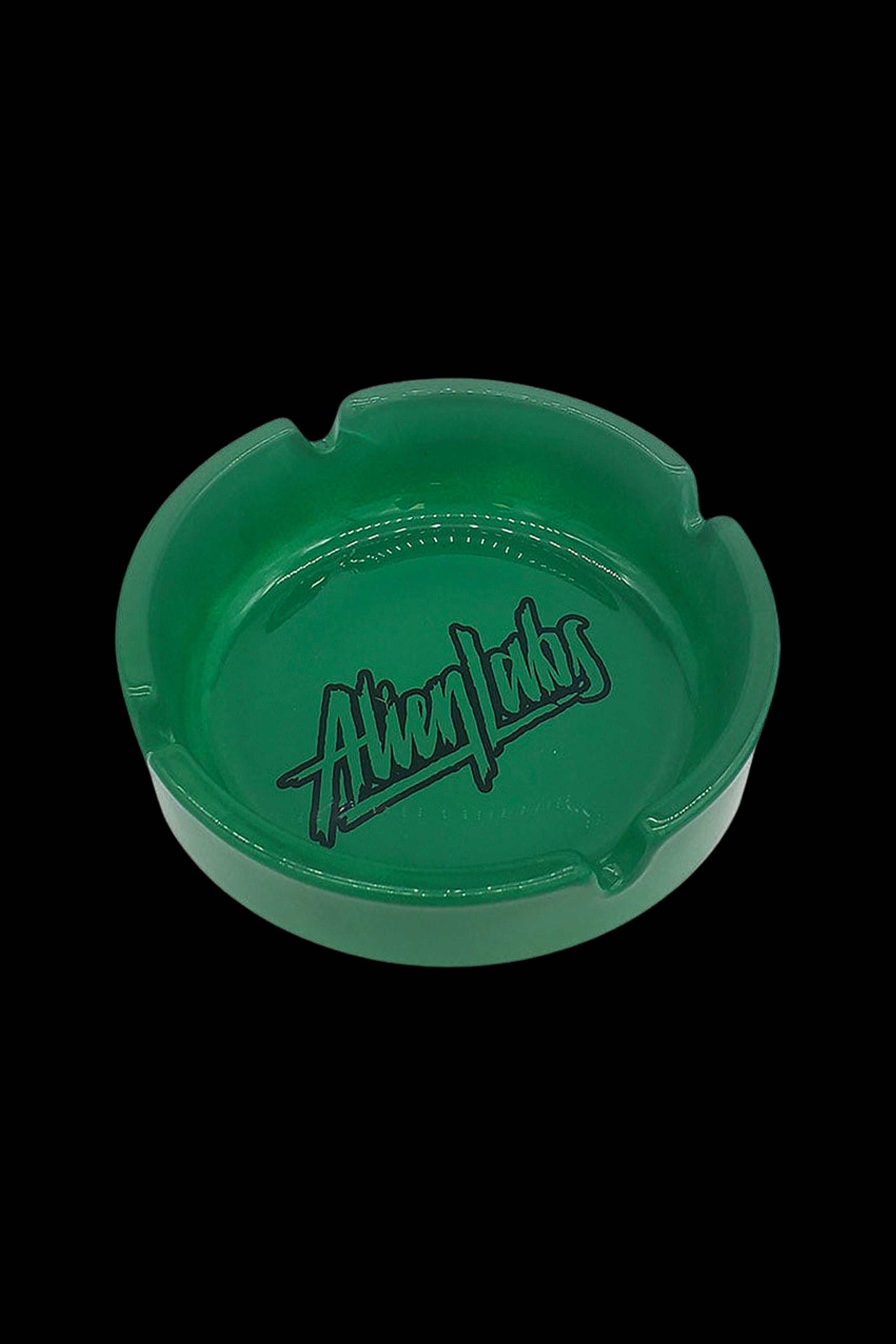 Green glass ashtray with “Alien Labs” logo.