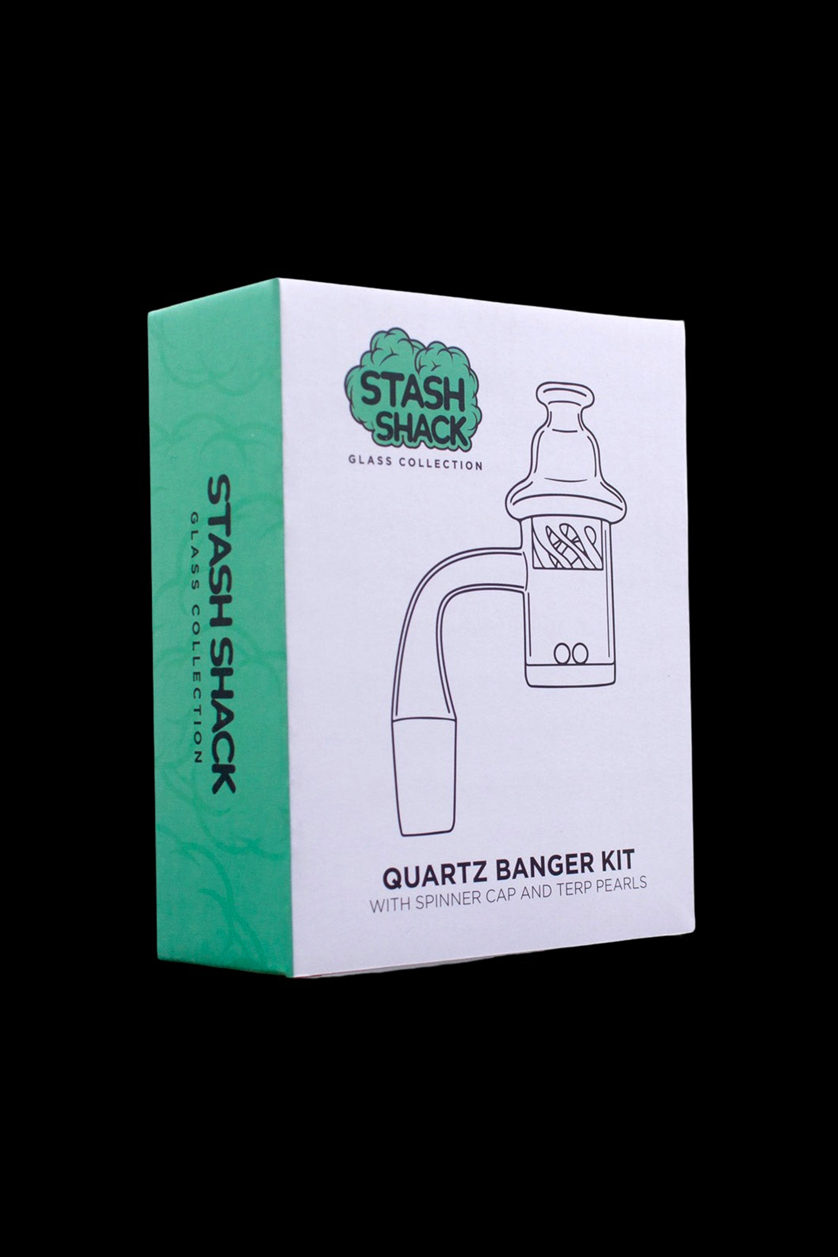 A green box for a “Stash Shack” quartz banger kit with spinner cap and terp pearls.