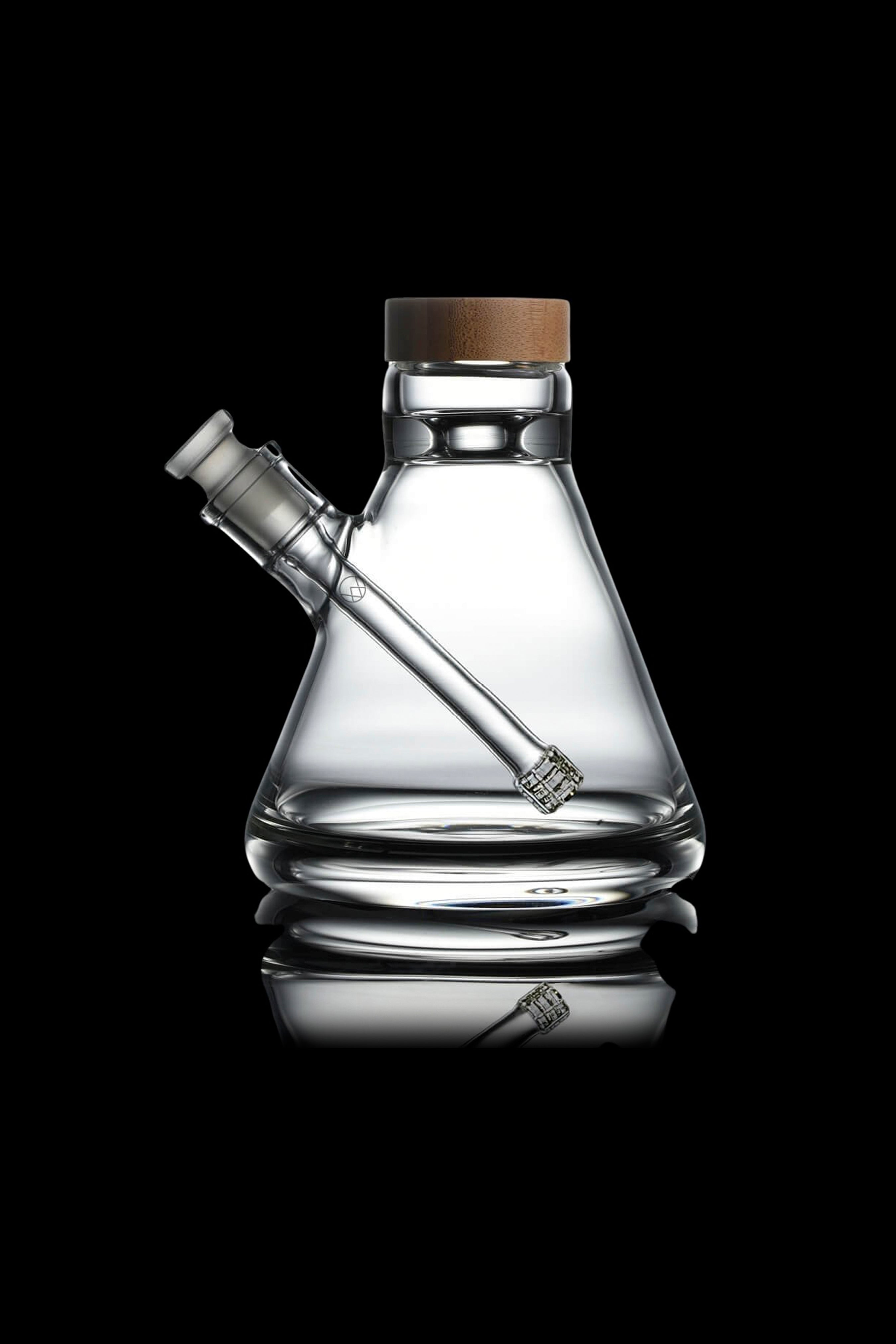 Clear glass water pipe (bubbler) with a wooden cap, studio shot on a reflective surface.