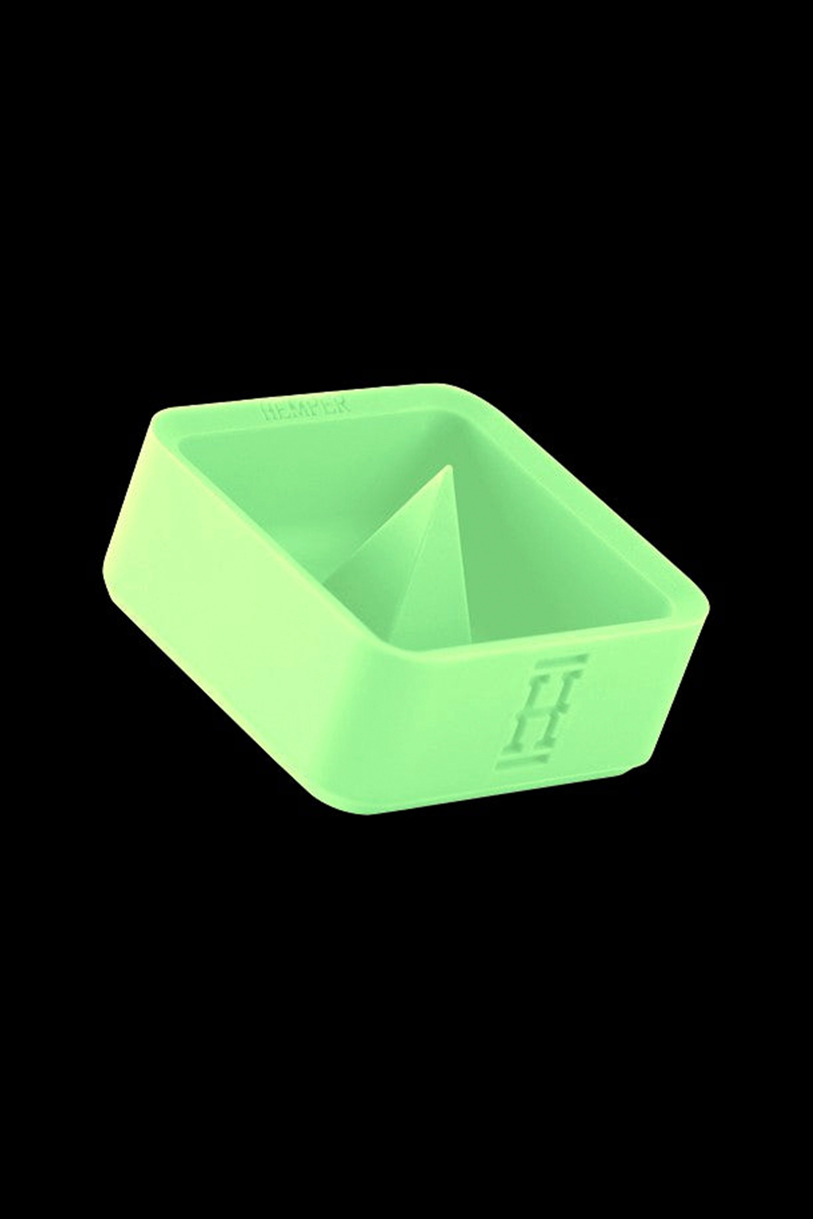 Neon green silicone concentrate container with a pointed internal structure, isolated on a black background.