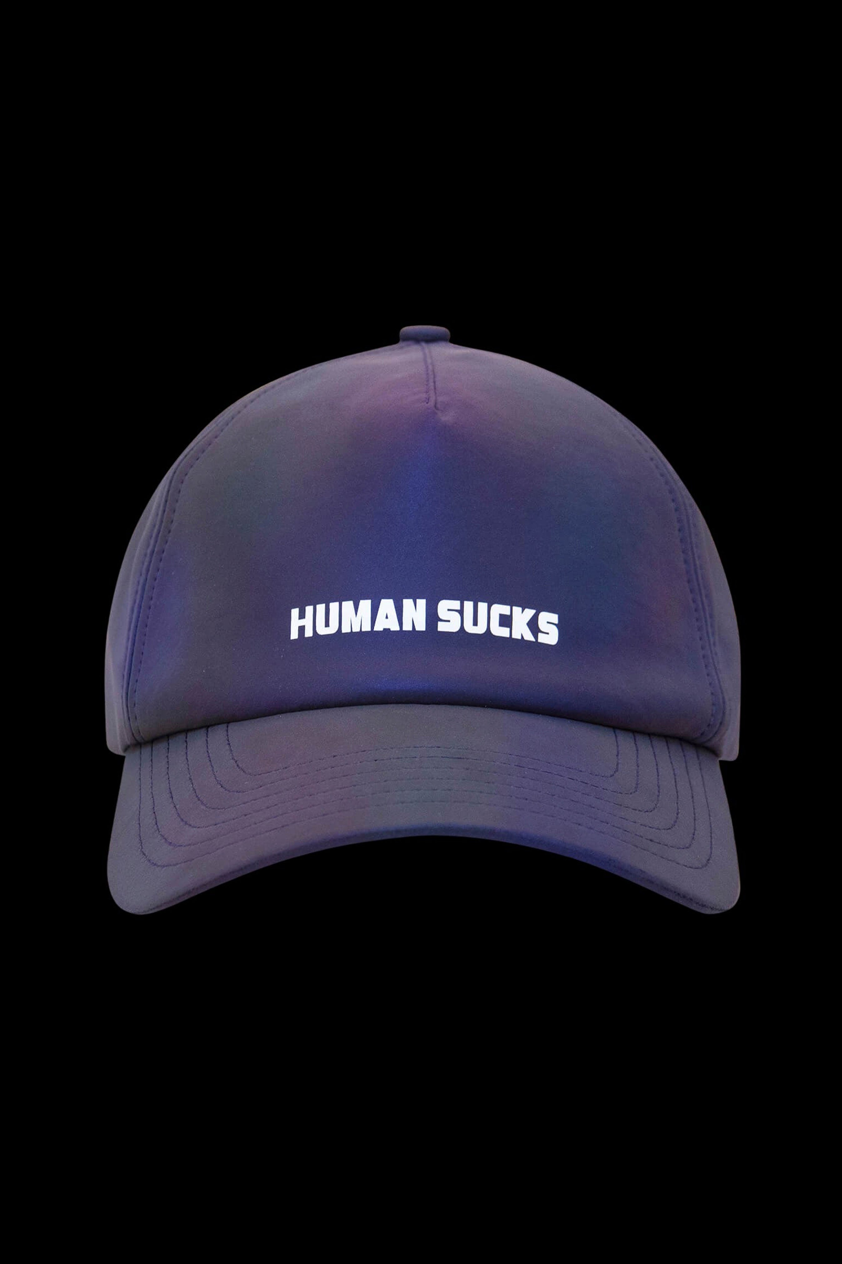 A vibrant blue and purple gradient baseball cap with “HUMAN SUCKS” embroidered in white across the front.
