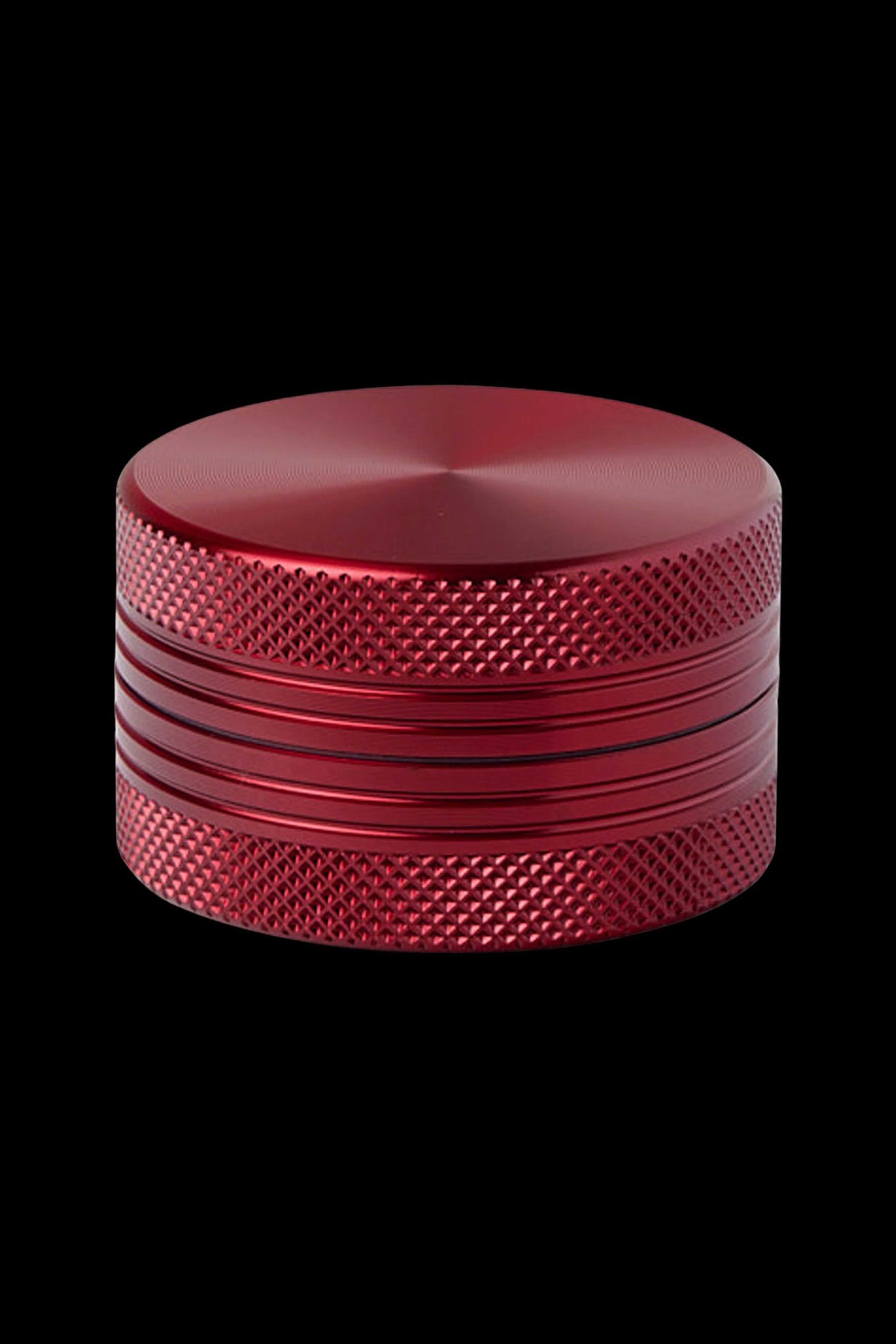 Red metal cannabis grinder.