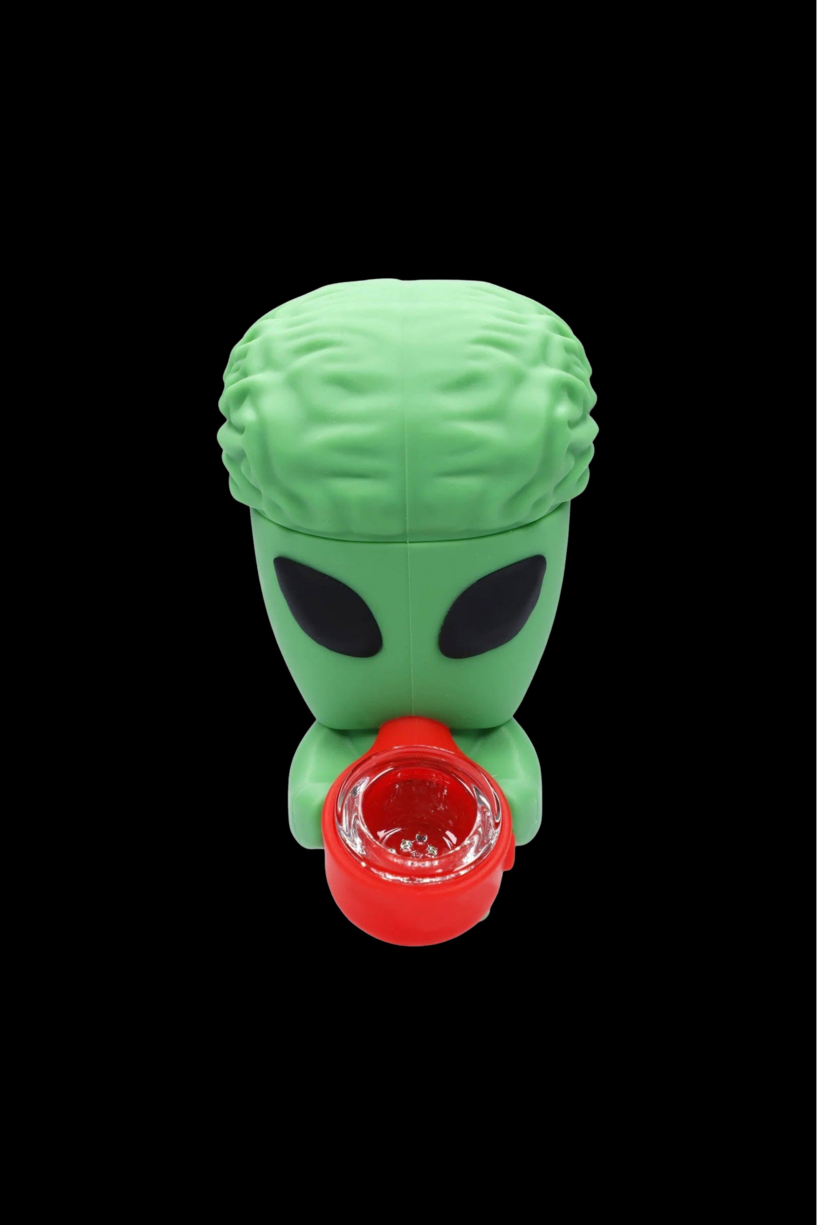 Green alien-shaped silicone concentrate container with a red mouthpiece.